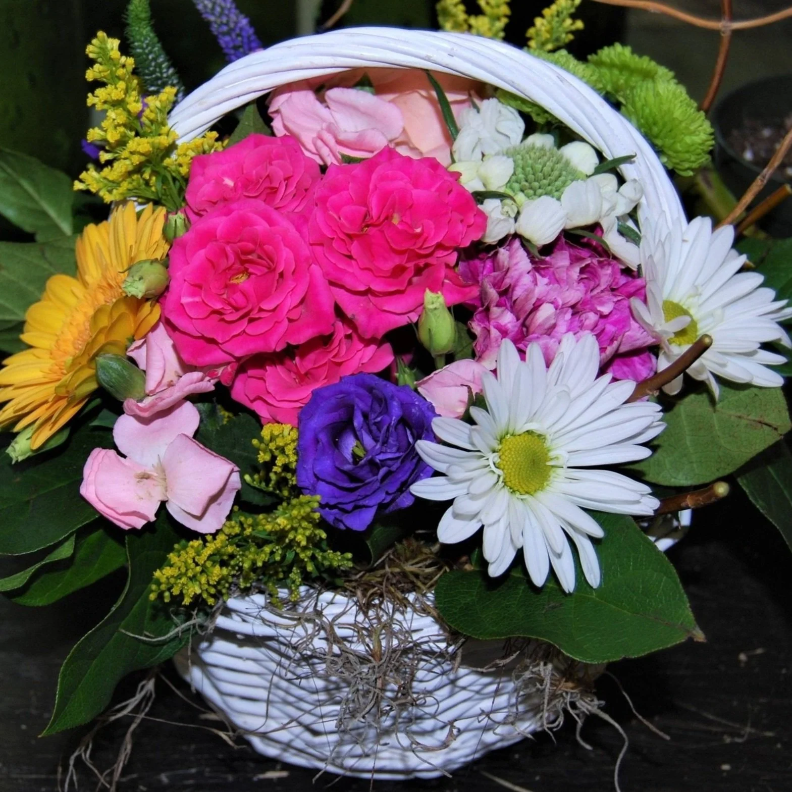 Easter Basket filled with daisies, hydrangea, spray roses, and other springtime flowers