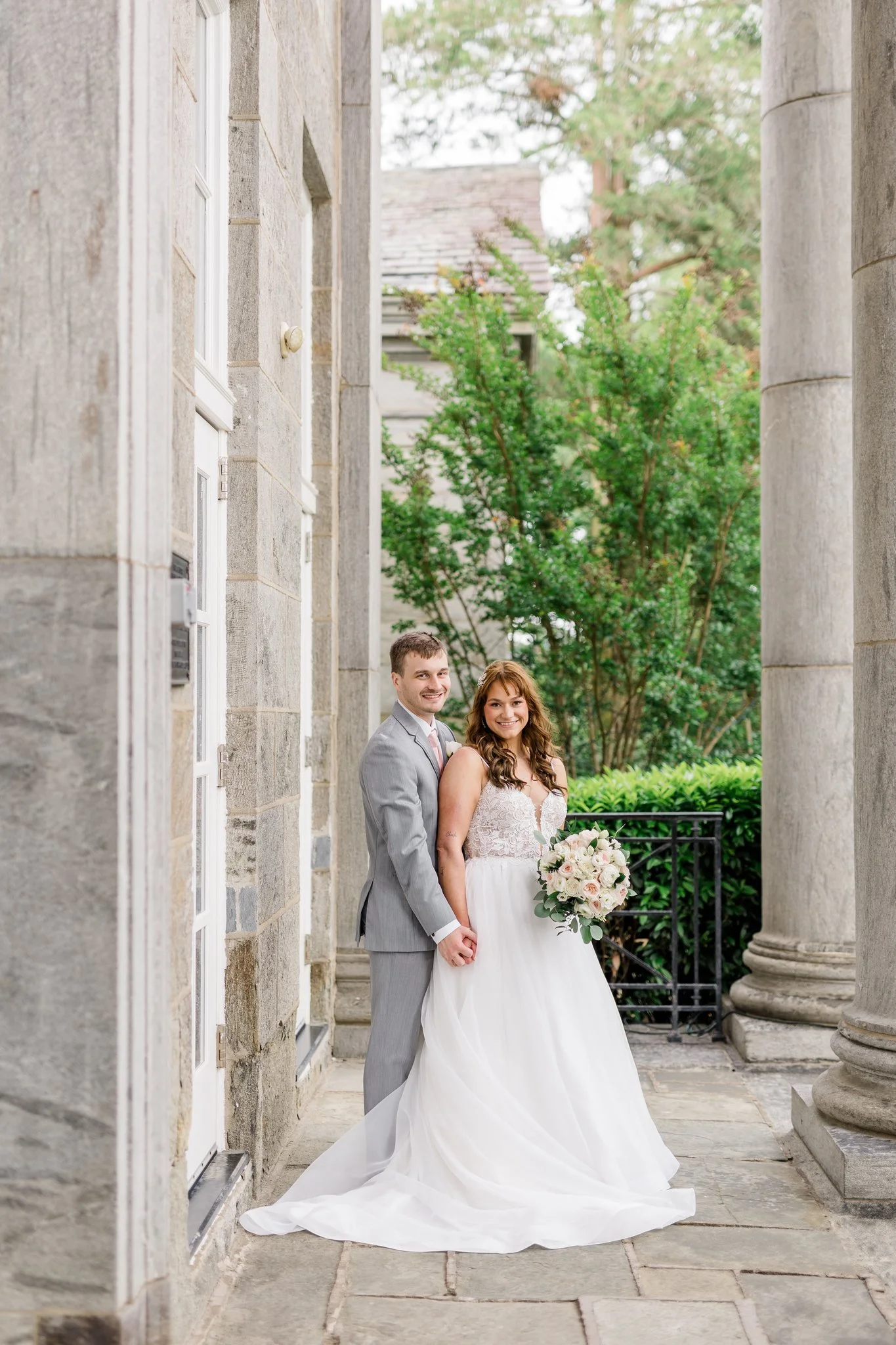 White and pale pink ranunculus bridal bouquet at the Ballroom at Ellis Preserve