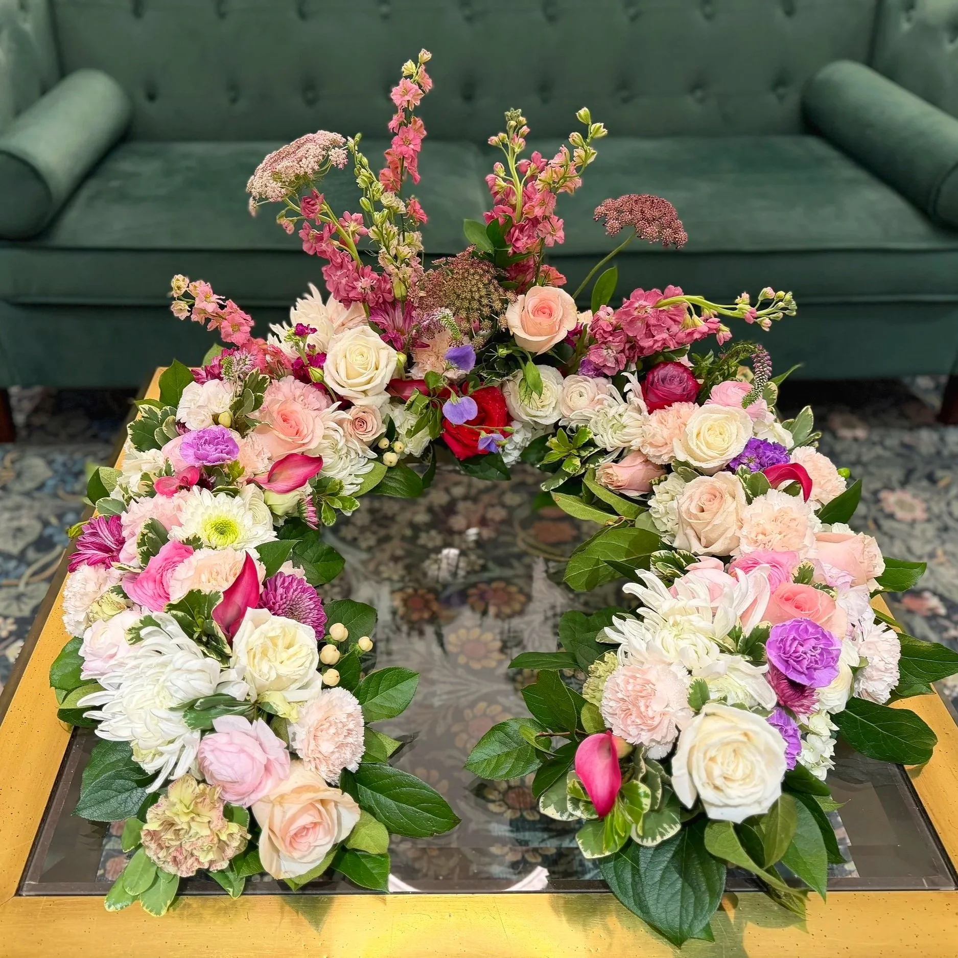 Memorial garden shaped in a horseshoe designed to surround an urn at a funeral or memorial service.