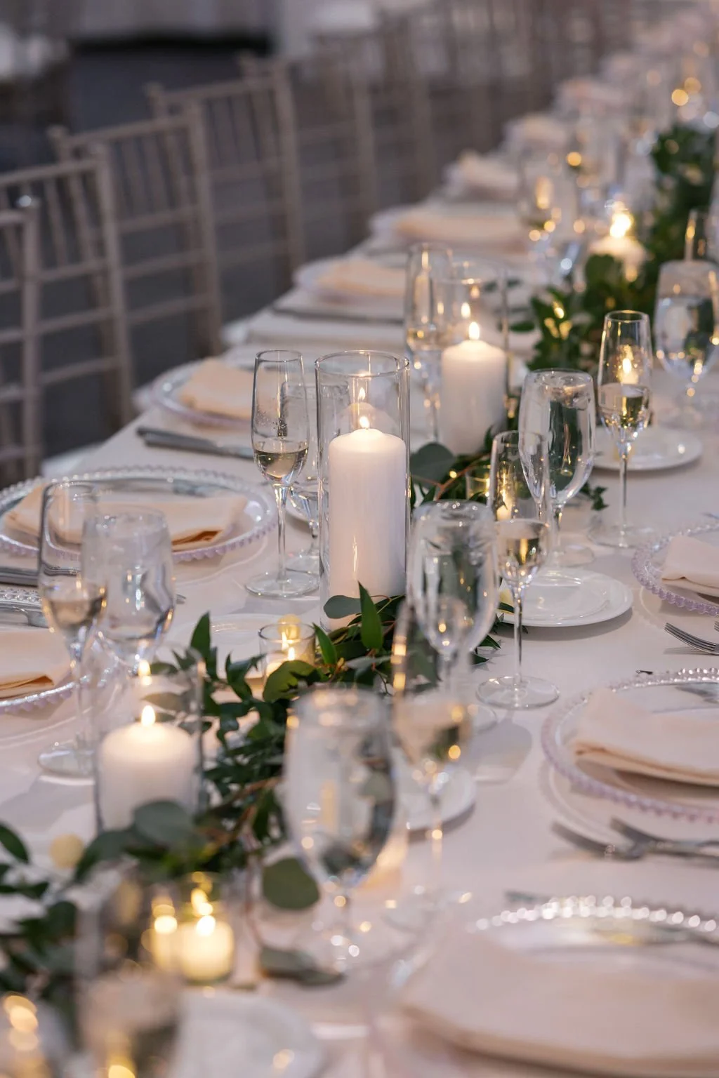 Greens garland with candles on rectangular table