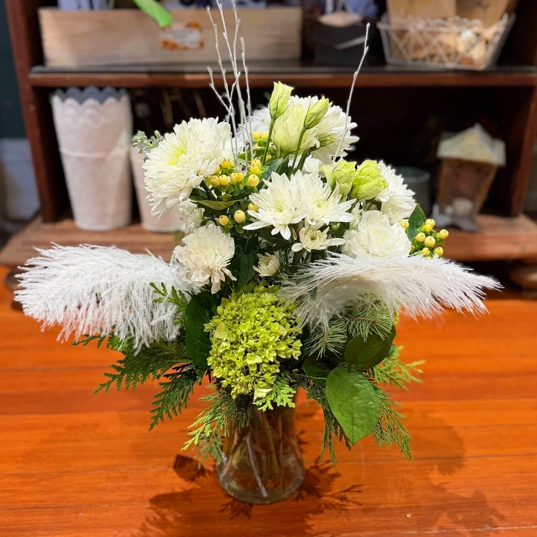 Happy New Year Flower Arrangement with white flowers, white berries, winter greens and white feathers