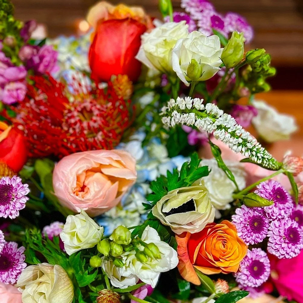 Custom designed sympathy flower arrangement featuring a fresh mix of seasonal blooms compassionately arranged by one our professional florists.