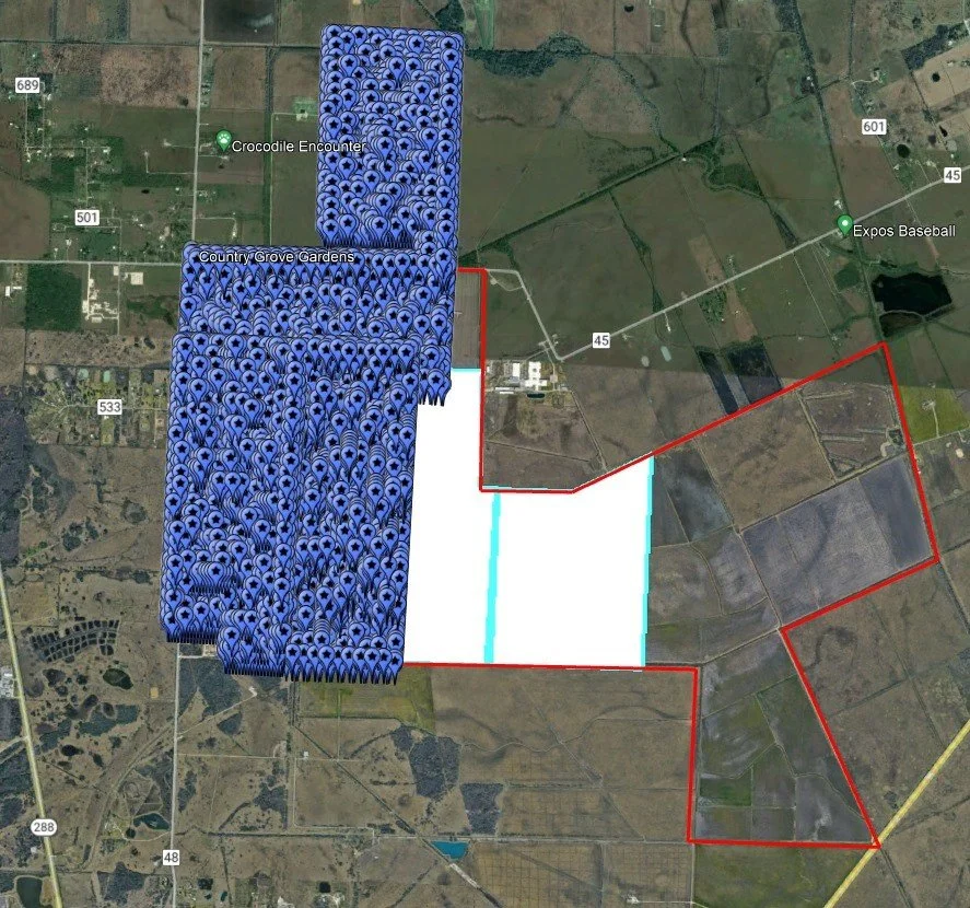 Satellite map showing property boundaries marked in red, blue, and white, with areas of dense blue icons indicating fields of solar panels near Crocodile Encounter and Country Grove Gardens, and surrounding roads and landmarks.