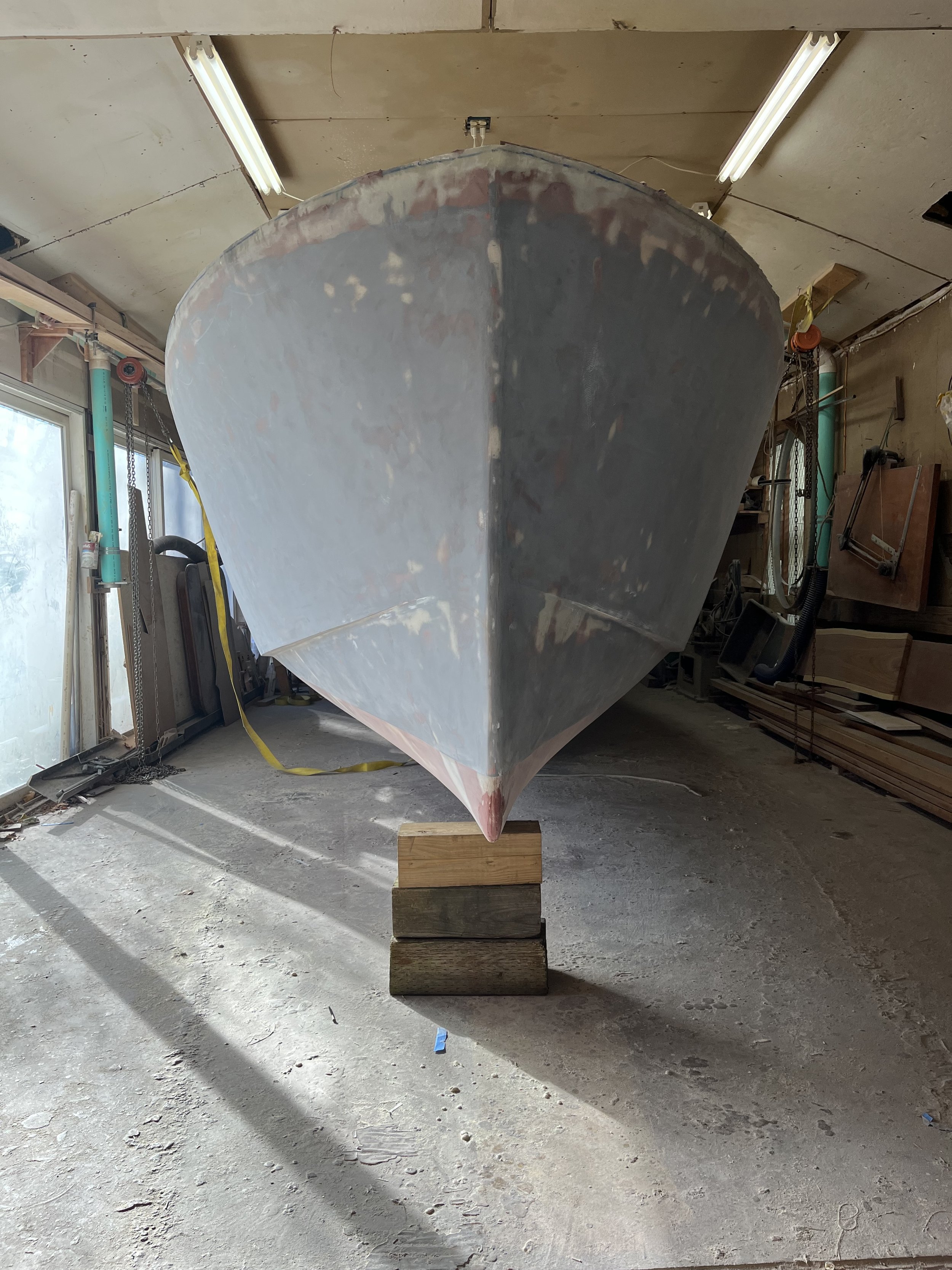    Exterior fiberglassing has been sanded and the boat has been flipped right side up, in preparation for interior fiberglass and structural work, December 2022   