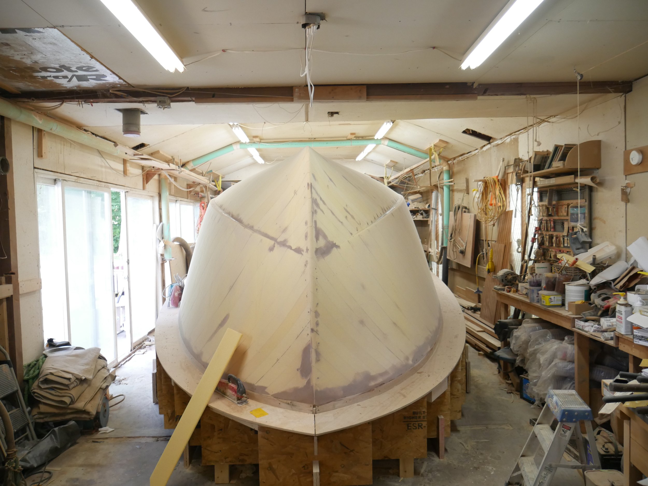    Corecell has been attached to the entire wooden form and it has then been filled, sanded, shaved and shaped to provide a smooth and geometrically correct surface before the exterior layer of fiberglass, resin and epoxy is applied, September 2022  