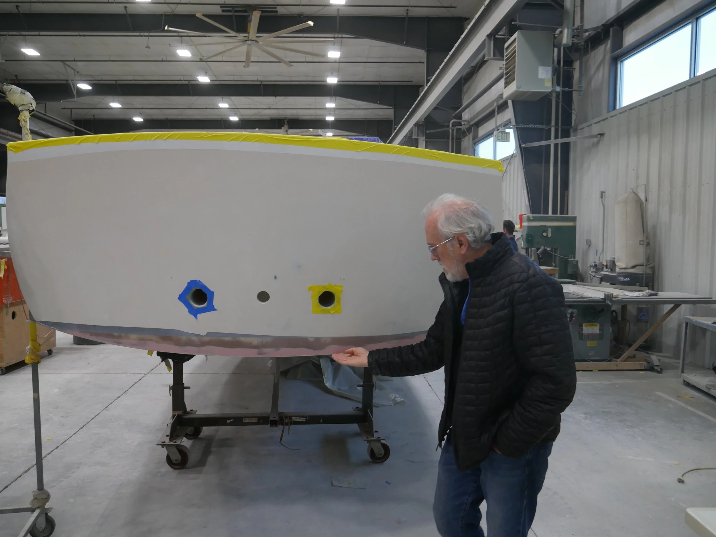    Dinty Child checks out the transom.&nbsp; The larger holes are outlets for the cabin scupper drains, and the hole in the middle is the discharge for the high voltage battery compartment vent system.   