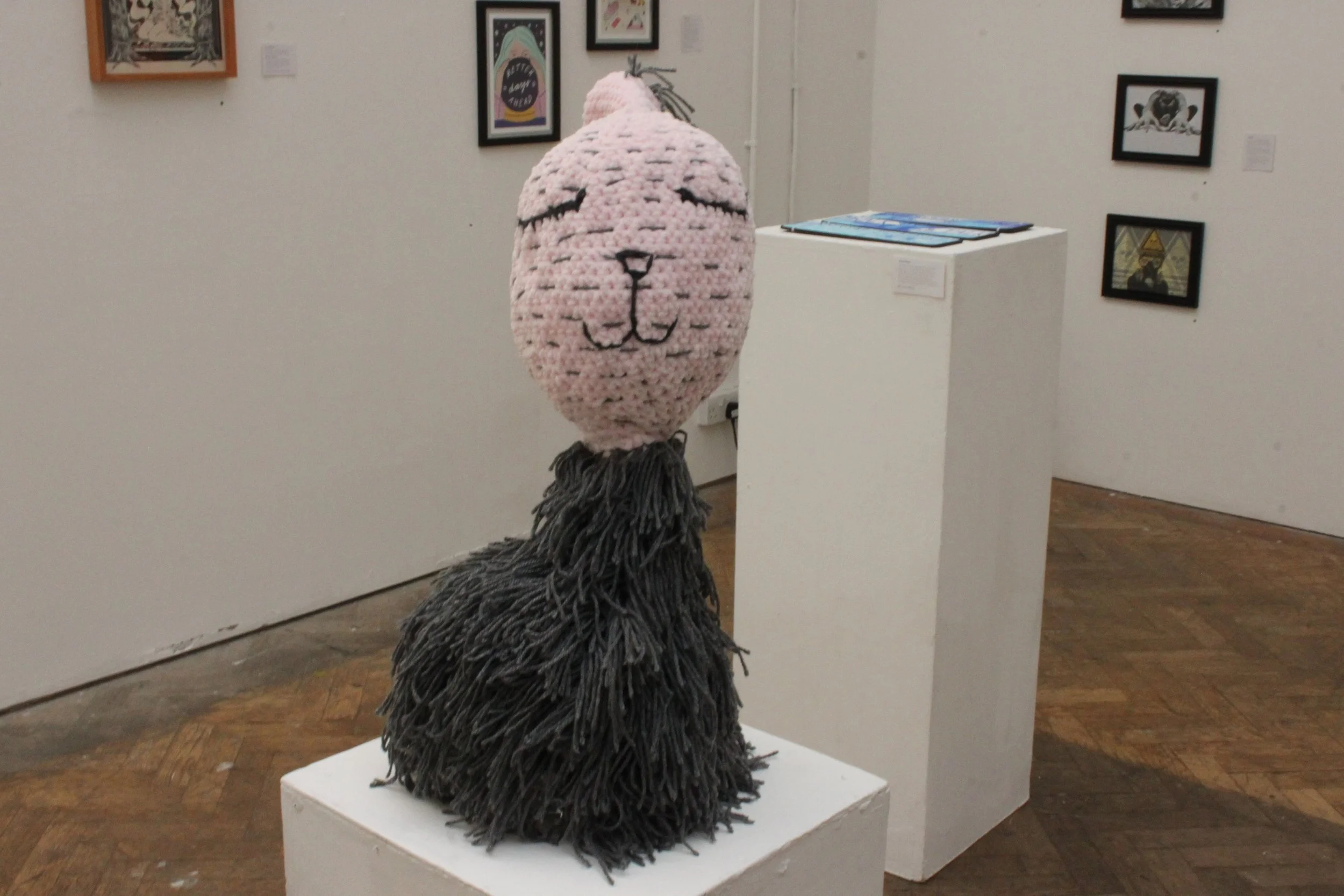 Soft limbless rabbit in gallery setting sitting on a plinth
