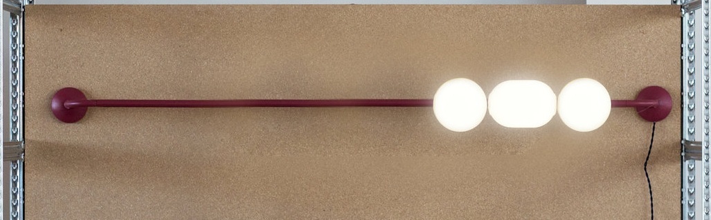 By moving the spheres on the rods, the light can be spread or accumulated. When the spheres touch the light gets stronger.