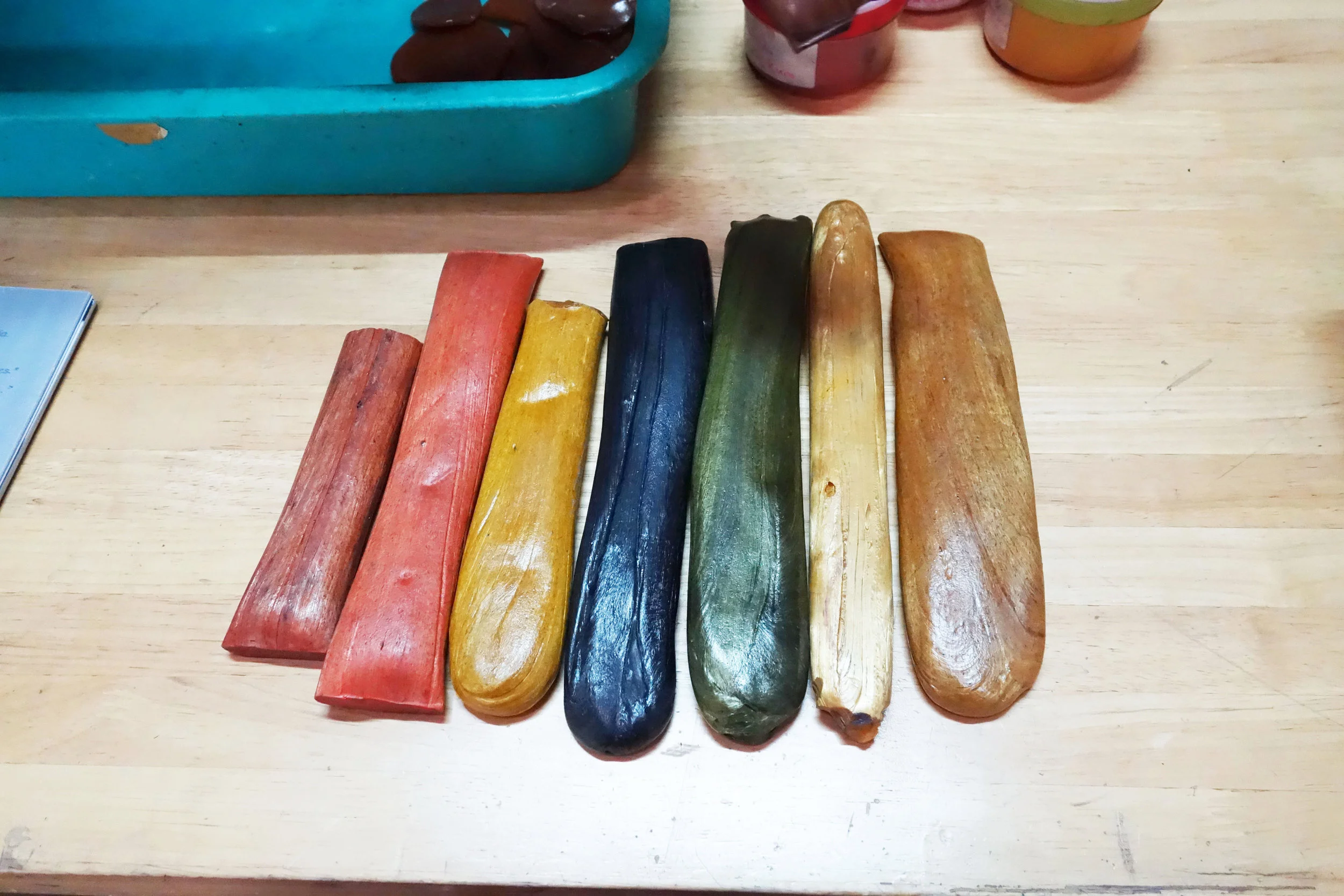 Shellack sticks dyed with indigo, turnmeric and various barks and natural pigments.