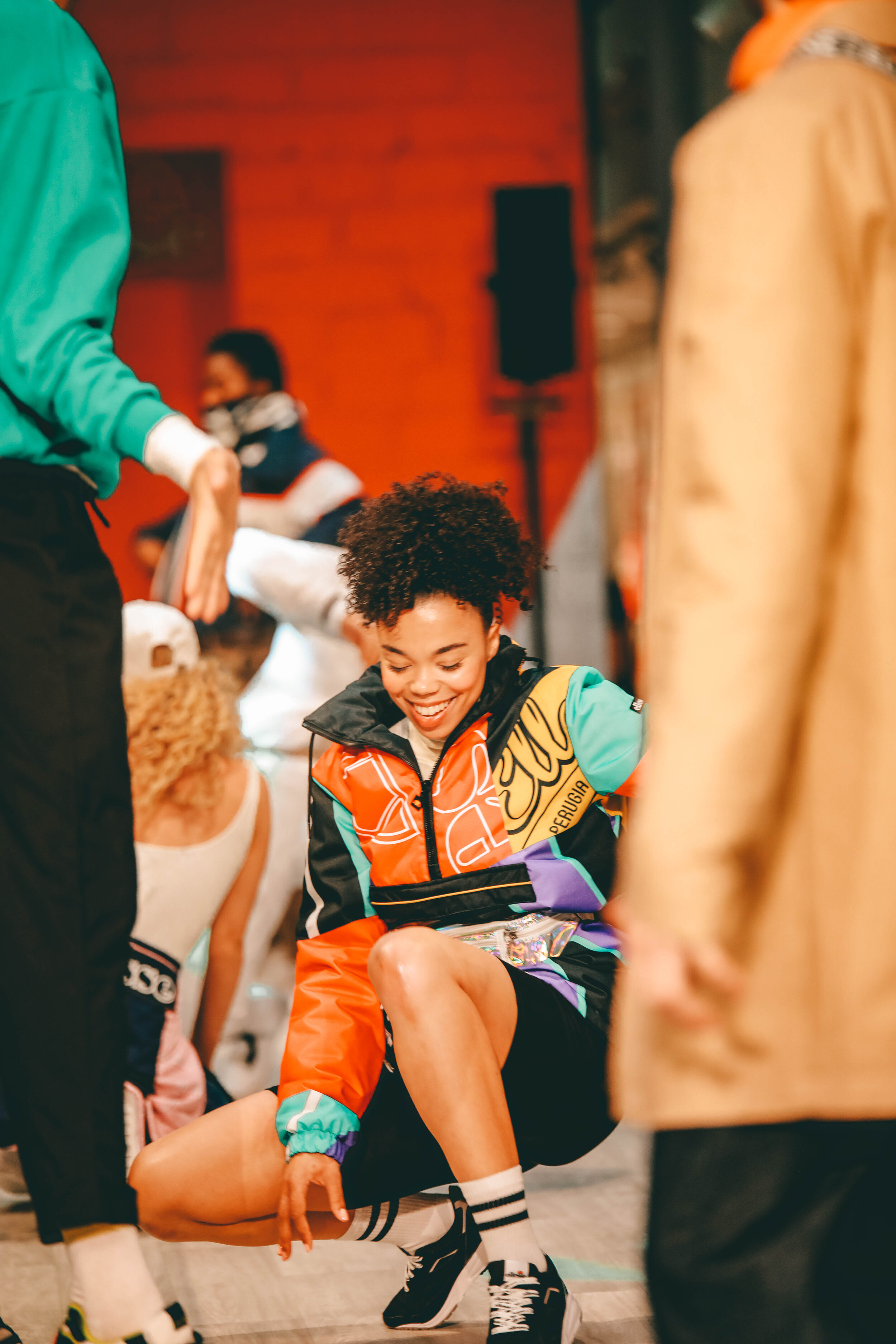  girl dressed in 90s style outfit on catwalk smiling 