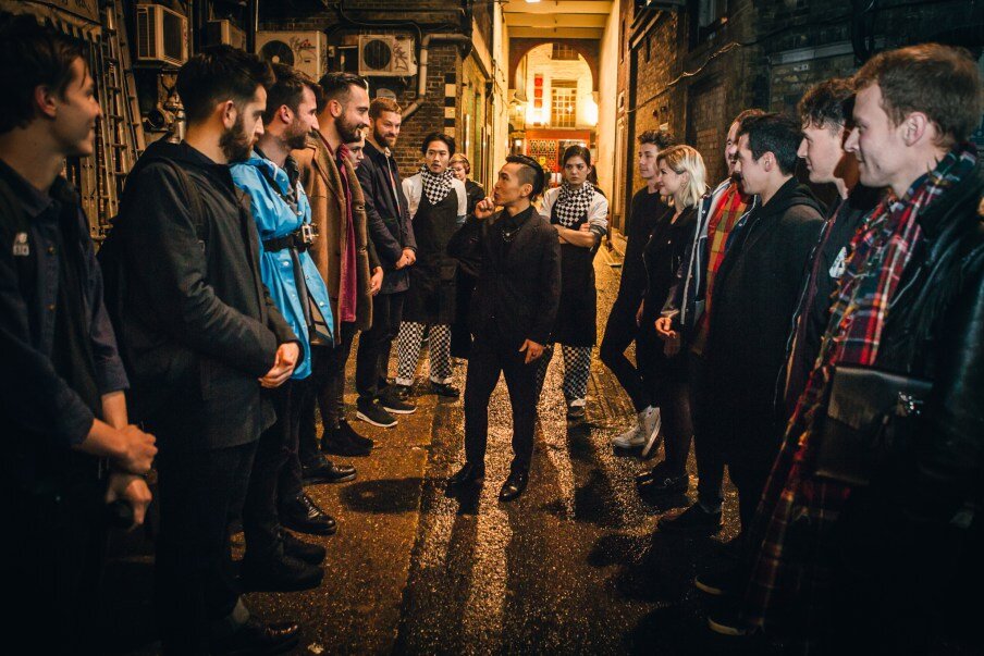  Team being briefed on a task in dark china town alley 