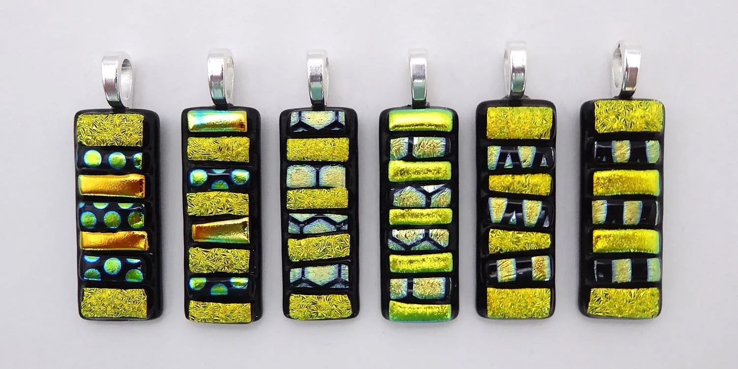Sparkling fused glass pendants in shades and patterns of gold dichroic glass