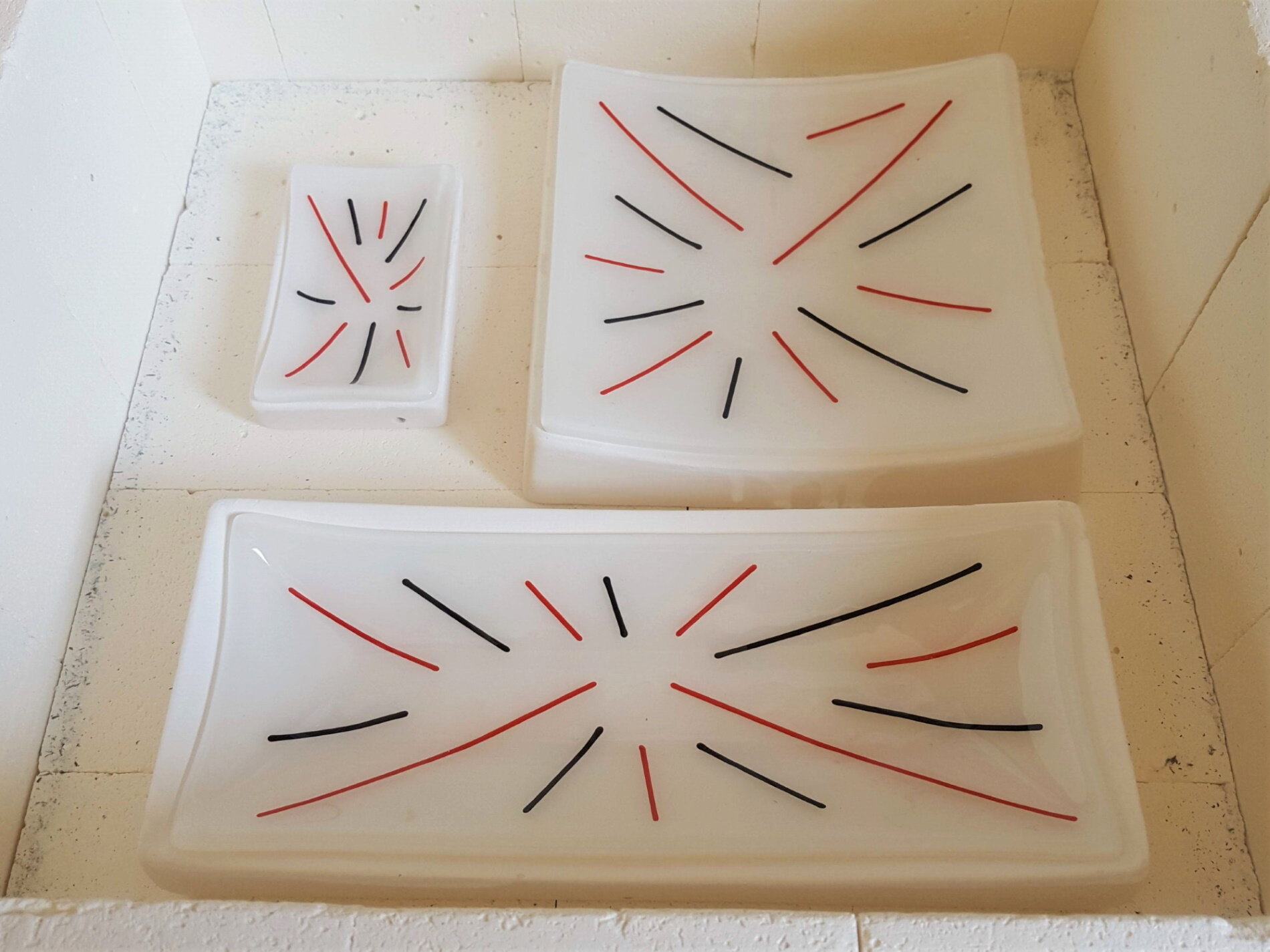 White fused glass homeware pieces.