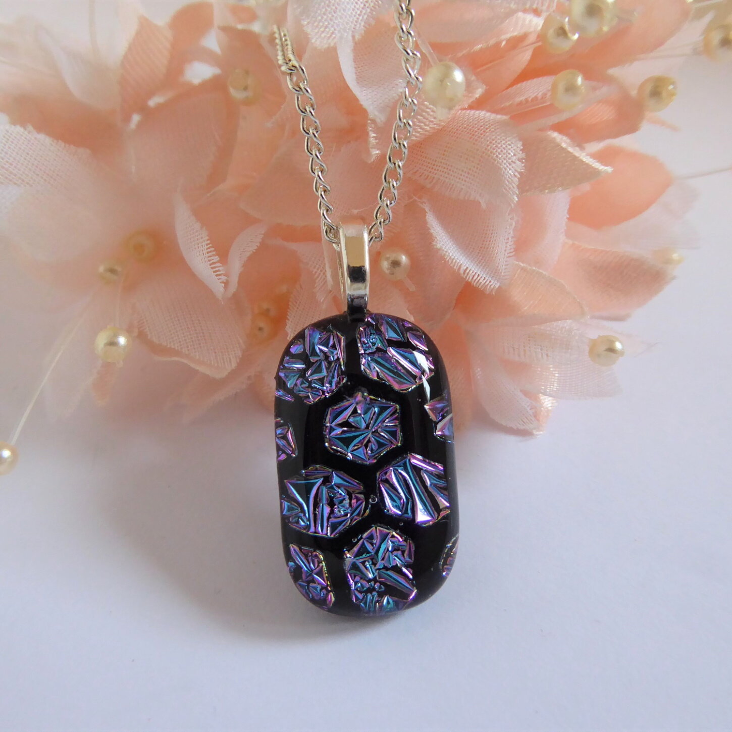 Blue fused glass pendant with a honeycomb pattern