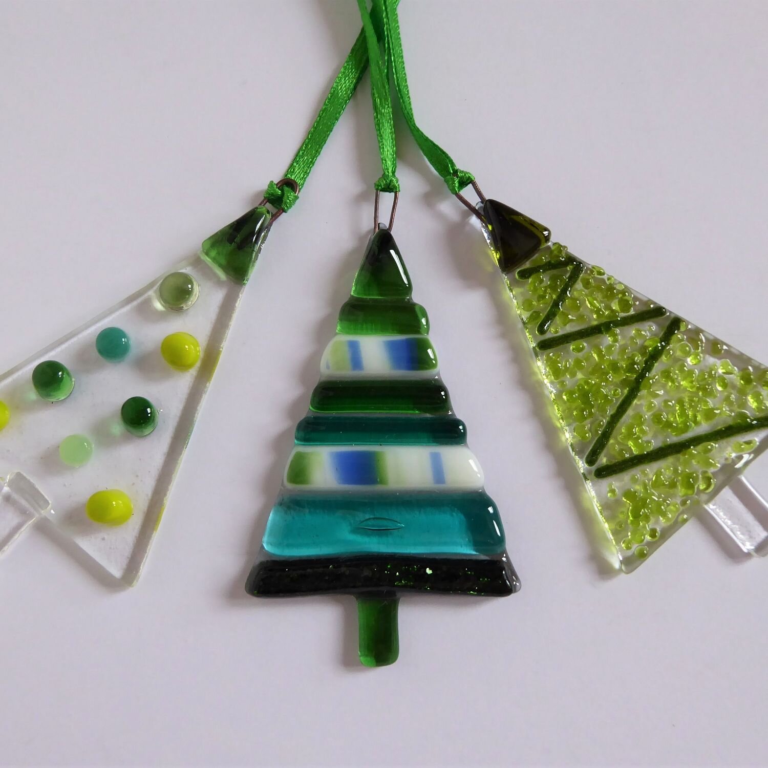  A set of three green fused glass tree-shaped Christmas decorations by Eva Glass Design 