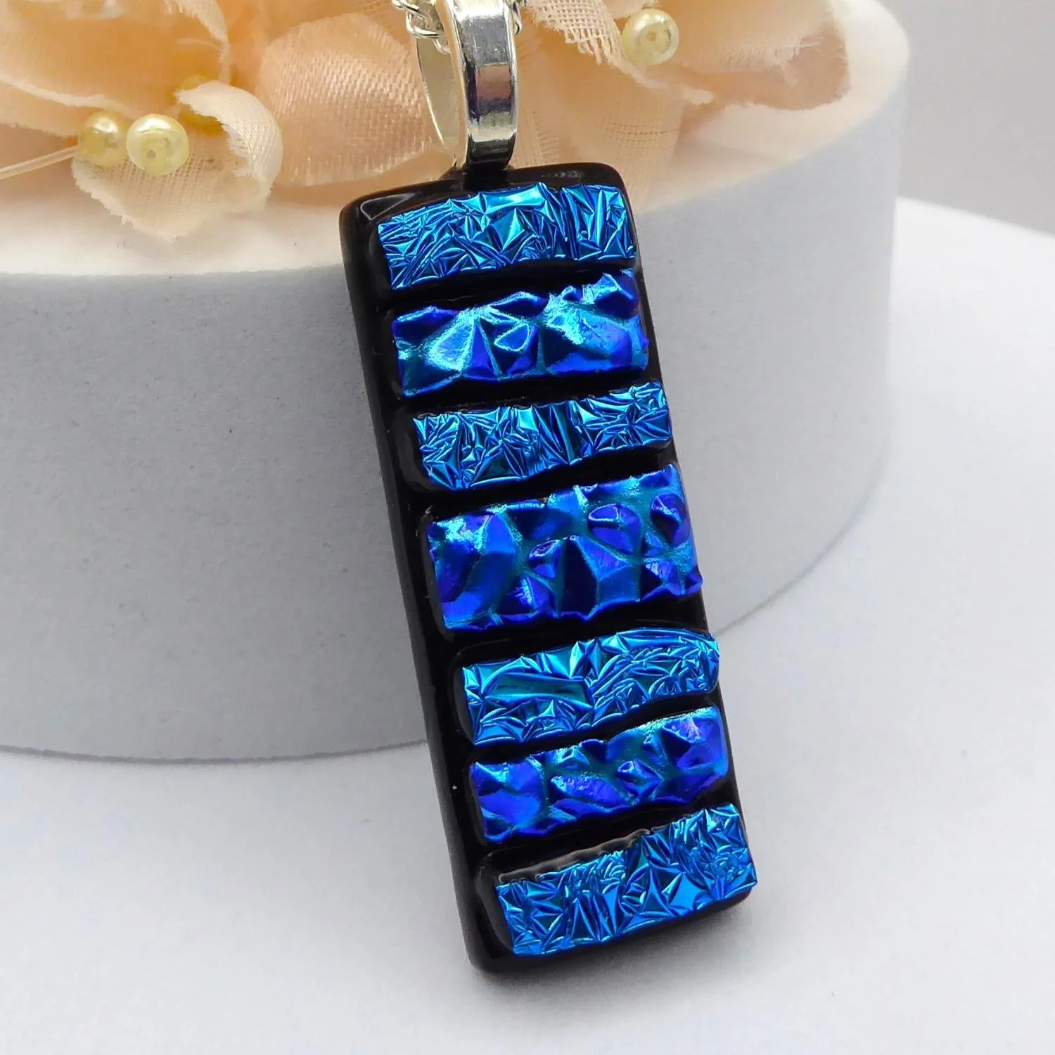  Handmade blue fused glass pendant made with strips of textured blue dichroic glass 