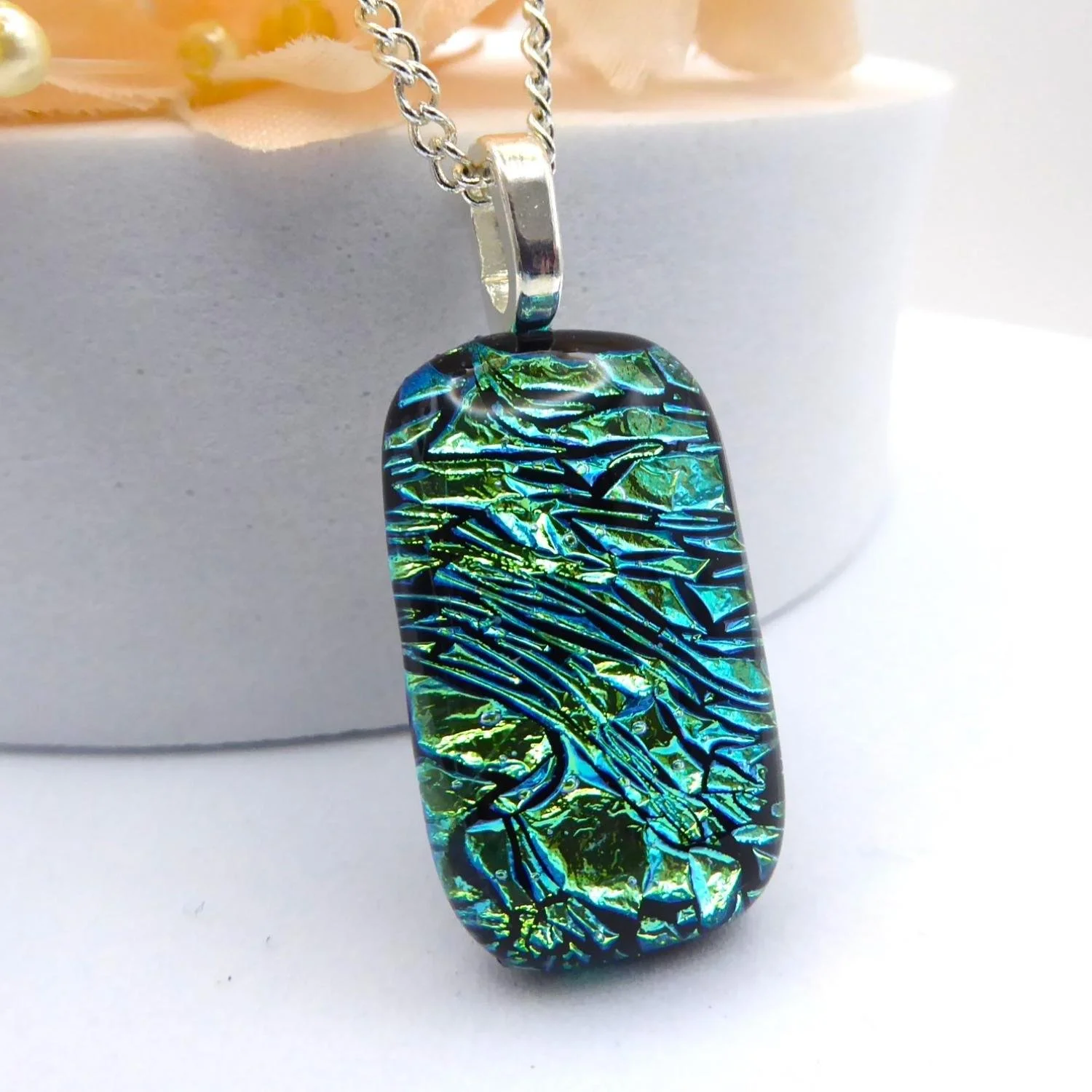  Fused glass pendant with silver plated chain made from pale green dichroic glass 