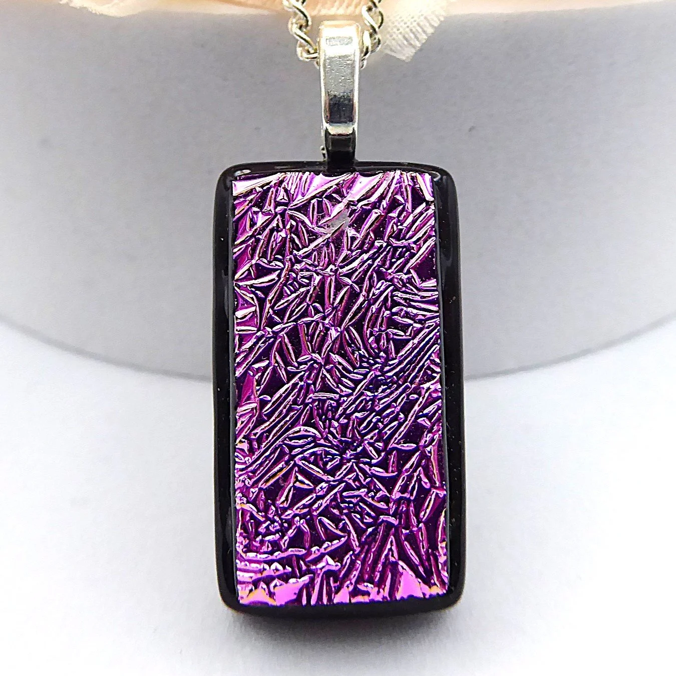  Pink and black fused glass pendant necklace with a textured pink glass on black glass 