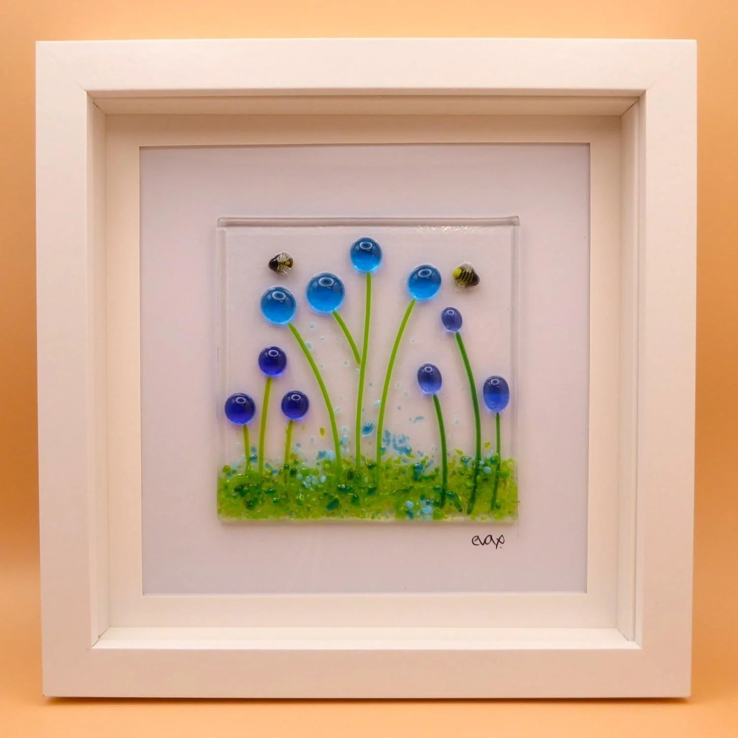  Floral fused glass wall art featuring bees and blue flower meadow. 
