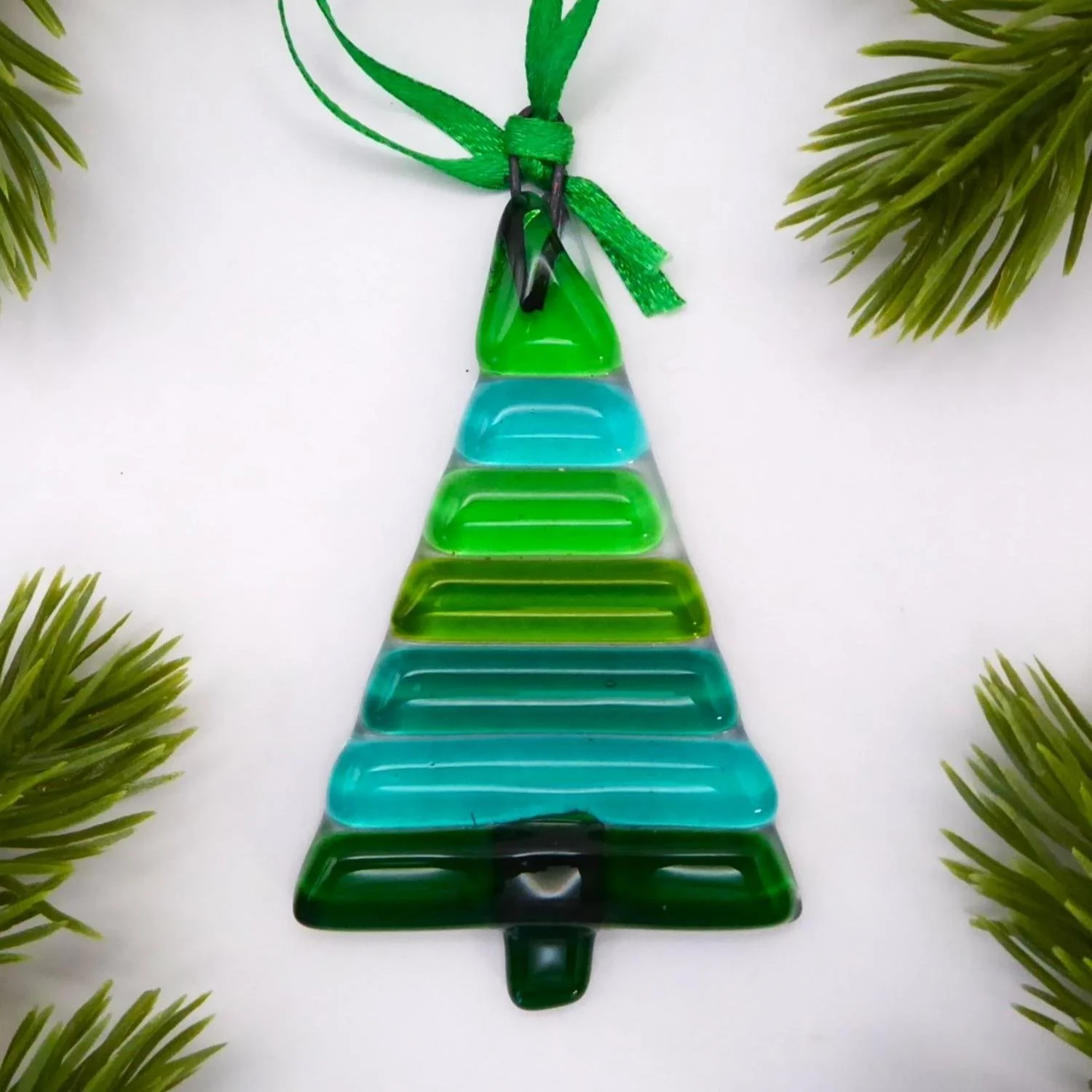  Hanging fused glass Christmas ornament with coloured green stripes on a clear background 