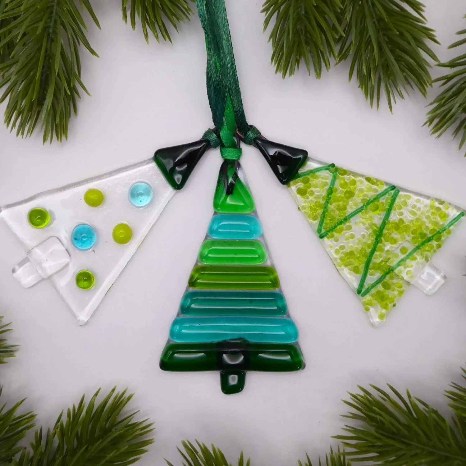  Set of three green fused glass Christmas tree ornaments 
