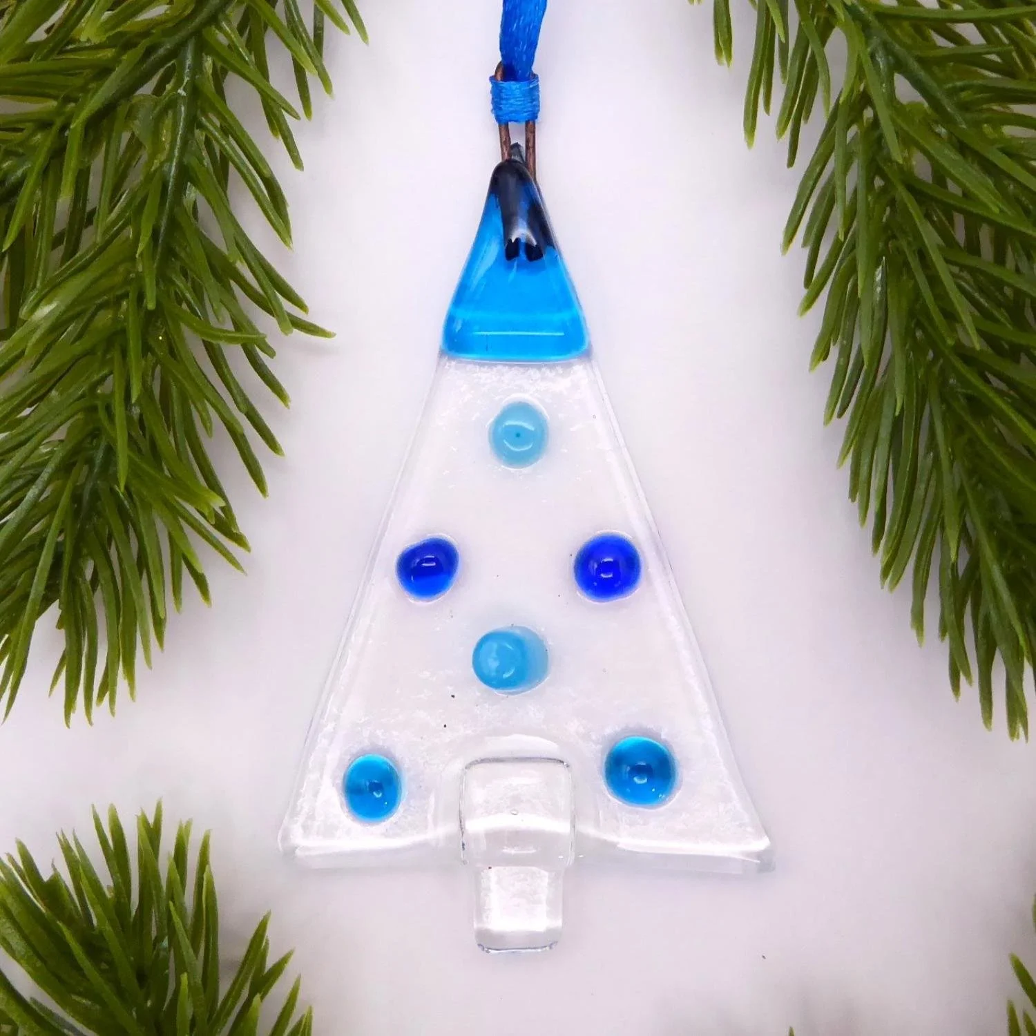  Festive glass Christmas ornament with blue spots representing baubles on a Christmas tree 