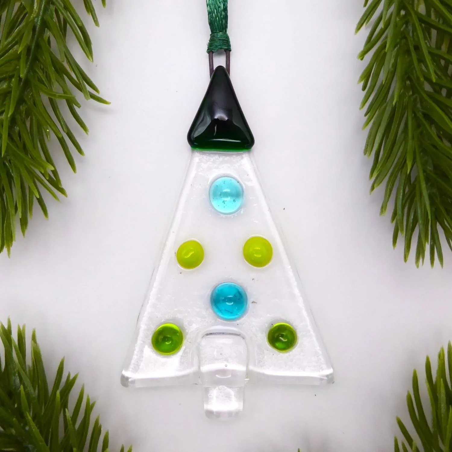  Fused glass Christmas ornament featuring green baubles on a clear background 