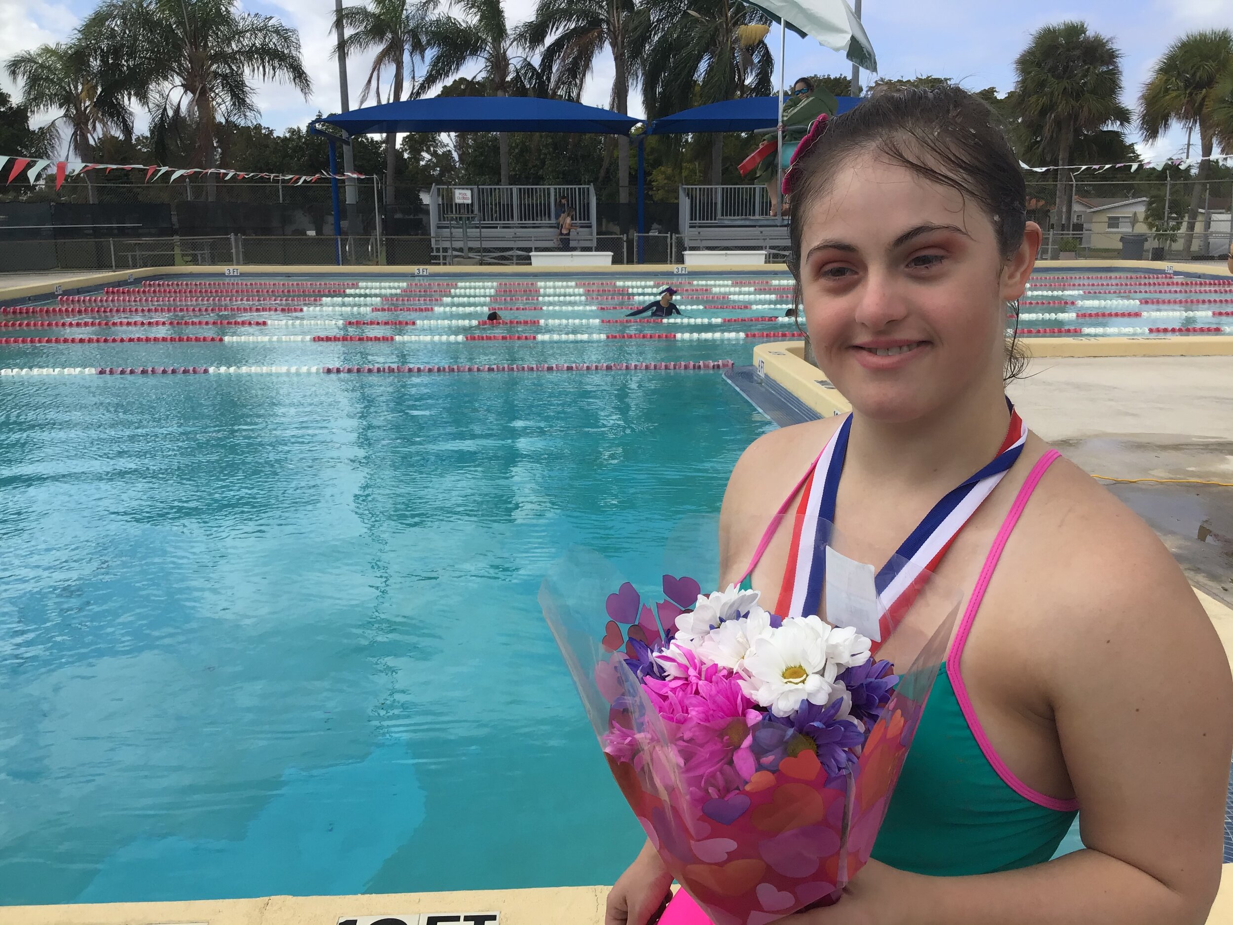 Valeria with flowers medal by pool.JPG