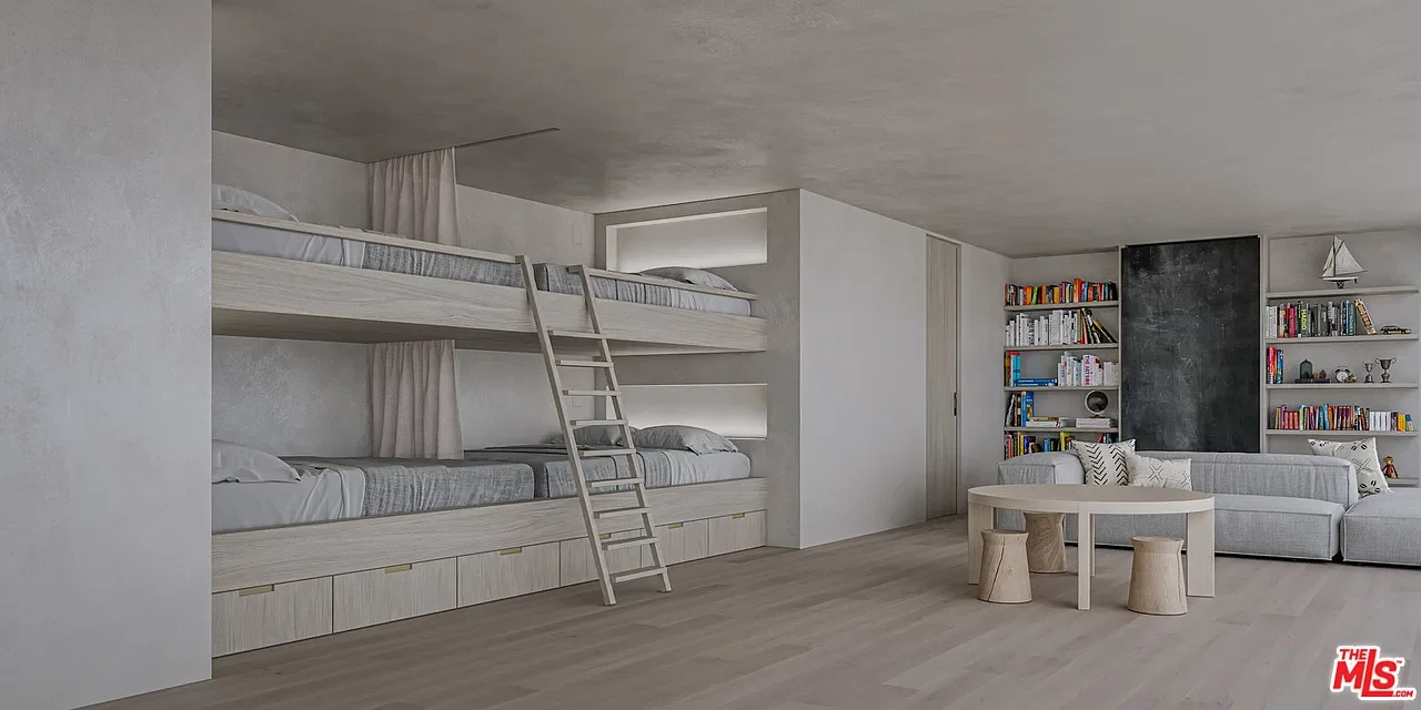 A modern, minimalist room with a bunk bed, a white sofa, a round white table, and bookshelves against the wall.