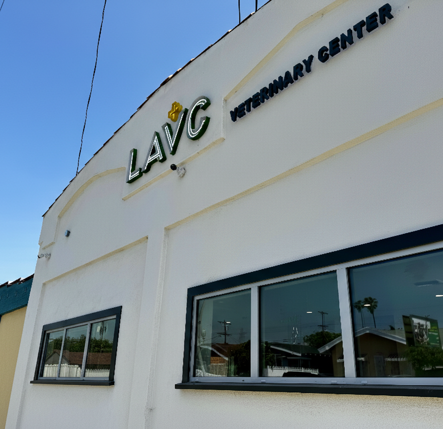 Exterior of a veterinary clinic with a sign that reads 'LAVC Veterinary Center' in front of a clear blue sky.