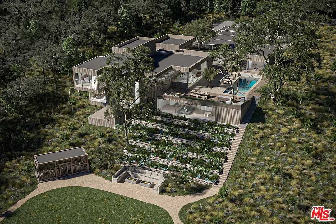 A modern house with outdoor amenities, including a swimming pool, tennis court, multiple decks, and a landscaped garden, surrounded by trees.