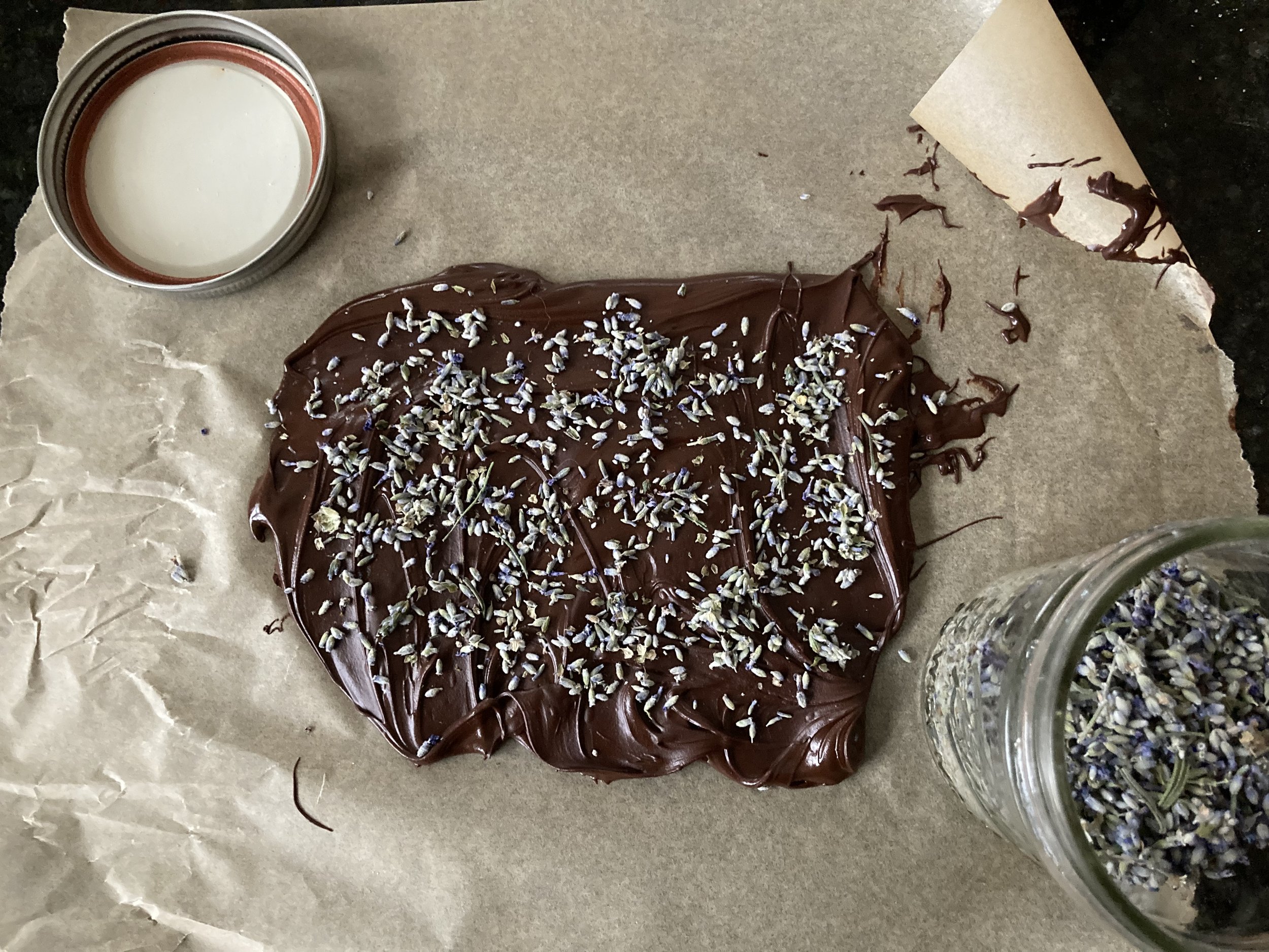 herbal lavender chocolate bark cooling on parchment paper