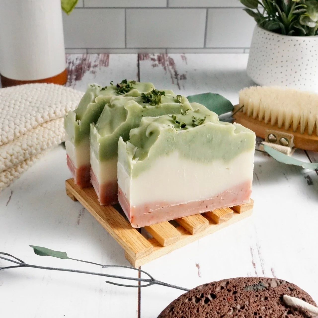 Eucalyptus and lavender herbal soap bars on wood table