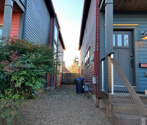 Narrow separations between newly built single-family row homes near NE Killingsworth are too small to grow a tree of any size.