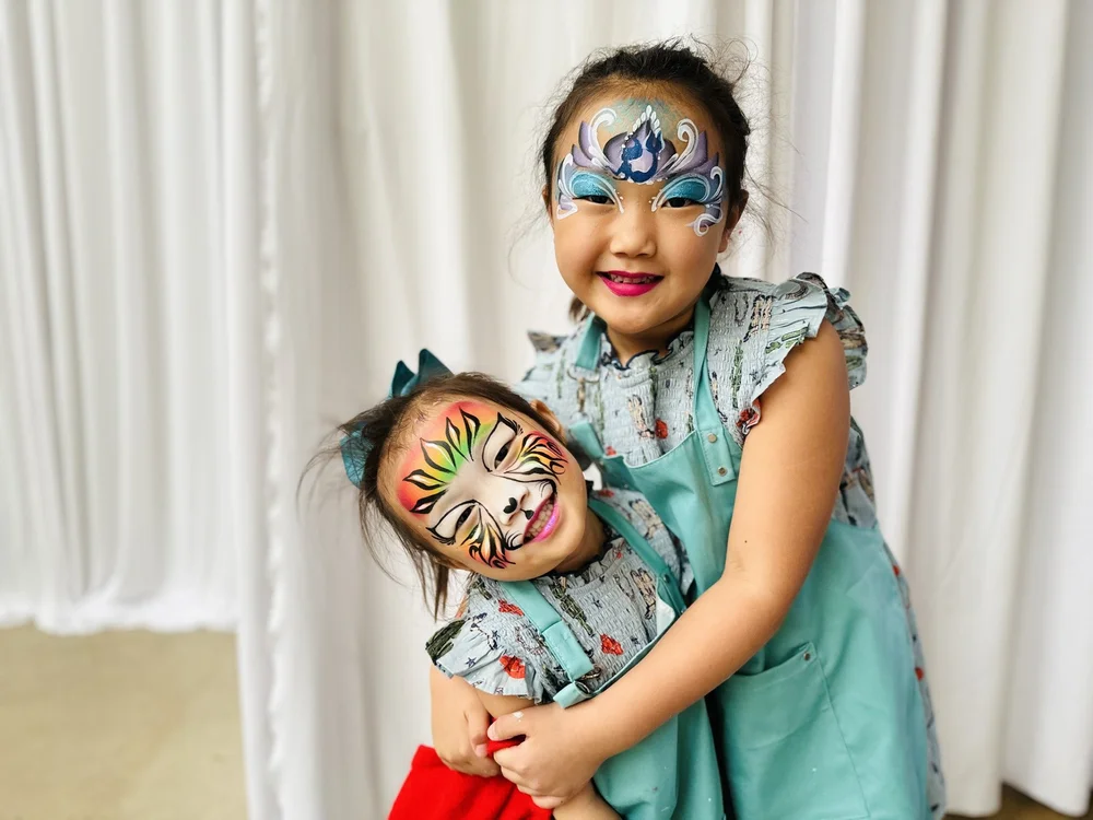 Children with colorful unicorn and tiger face painting