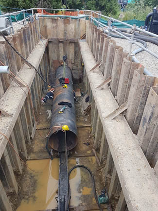 Incoming sewer thrust under creek