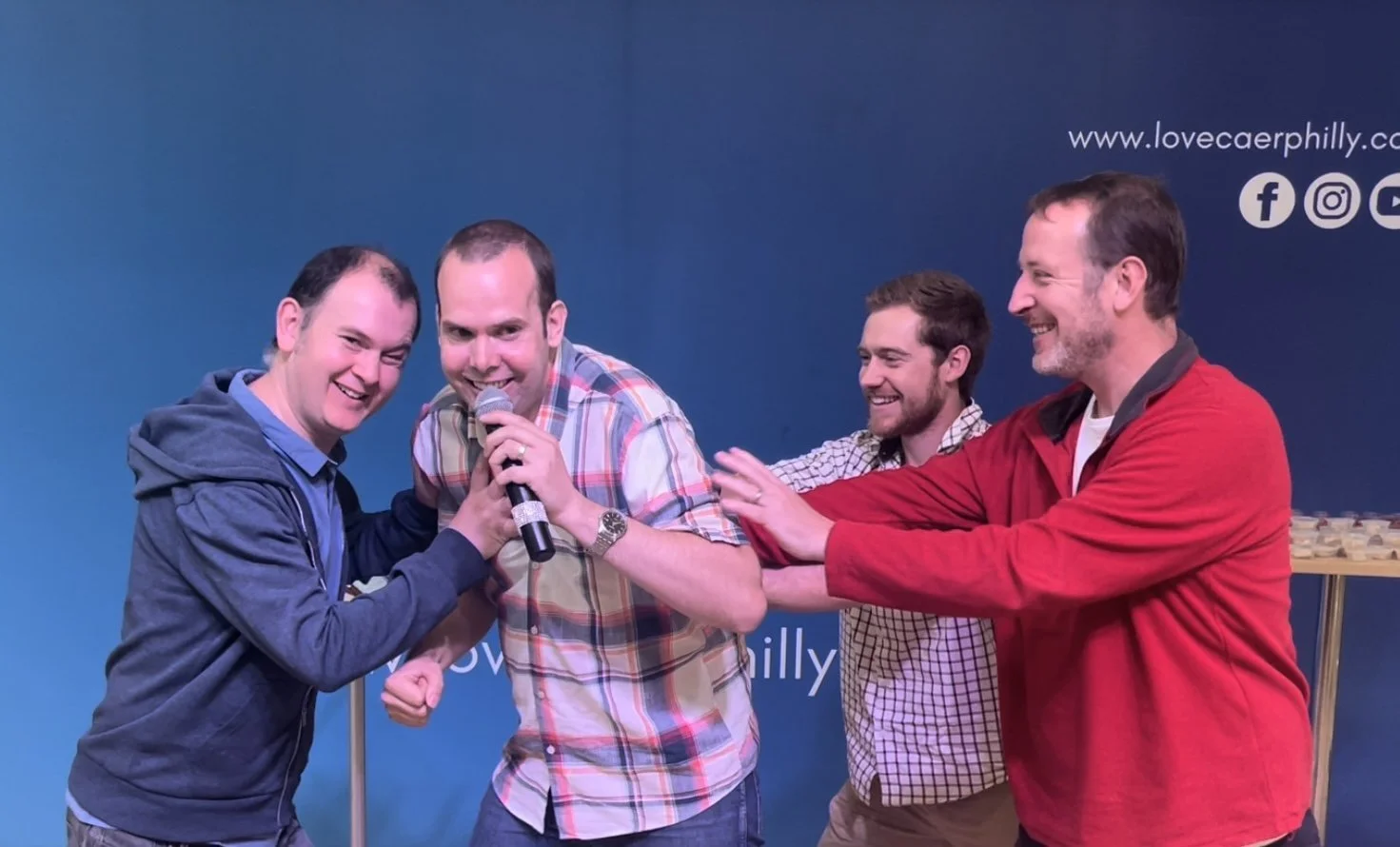 Group of men joke at church in Caerphilly