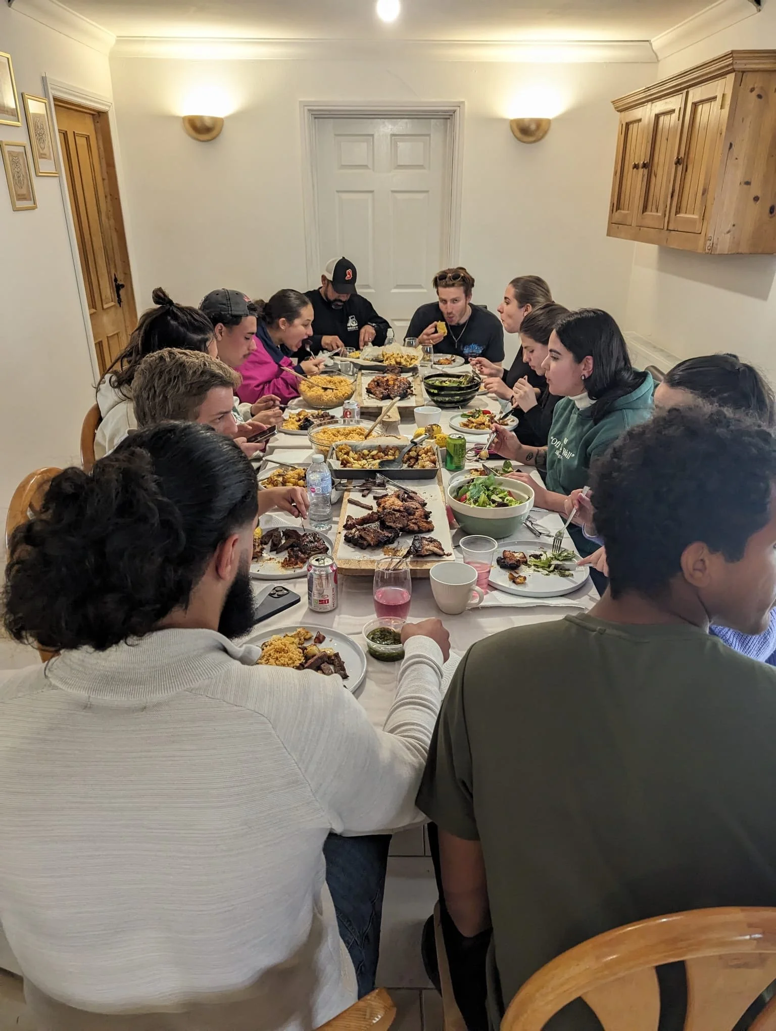 Young group of Christians around a table eating dinner