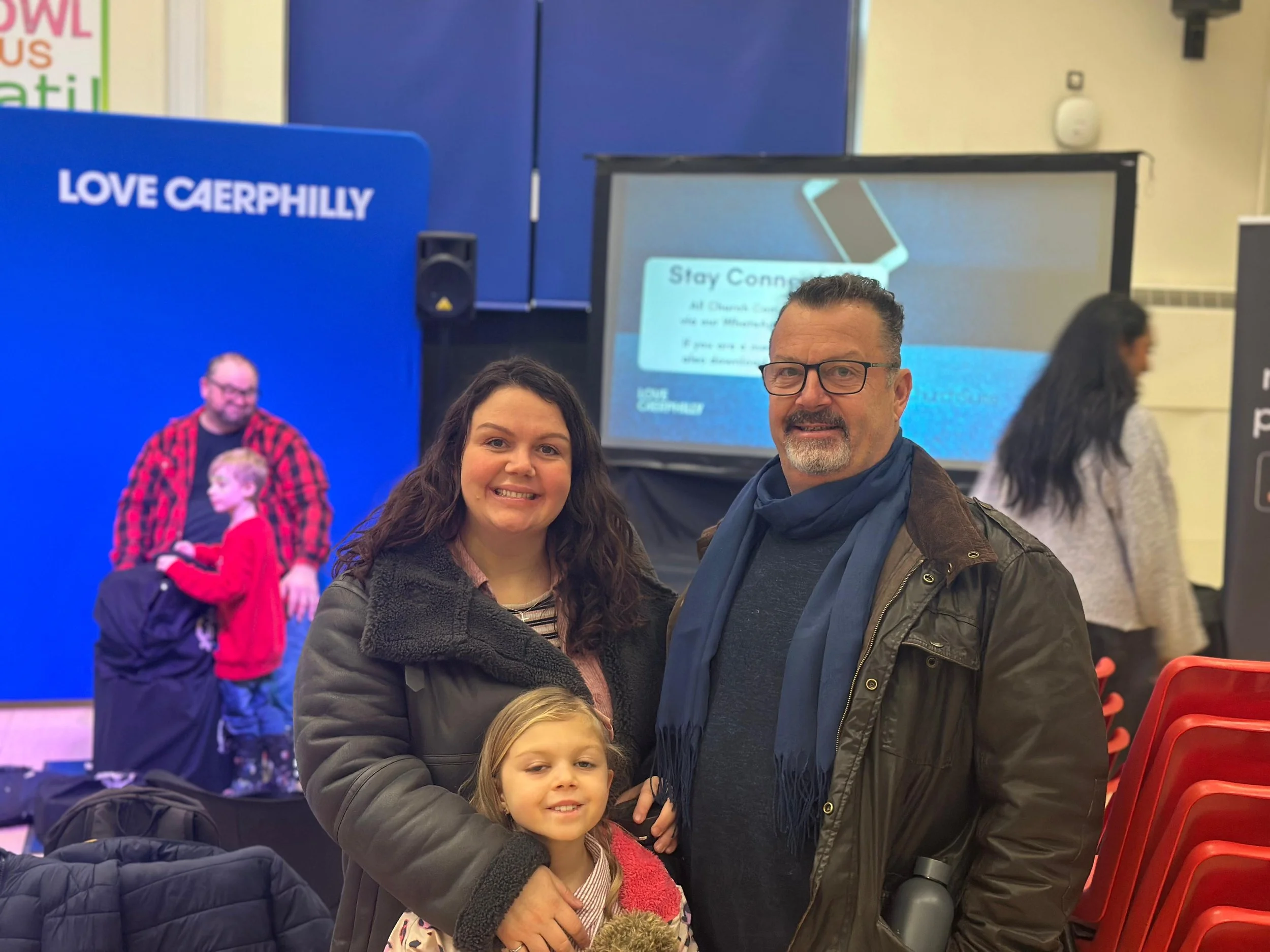 Smiling husband, wife and daughter at Love Caerphilly Church