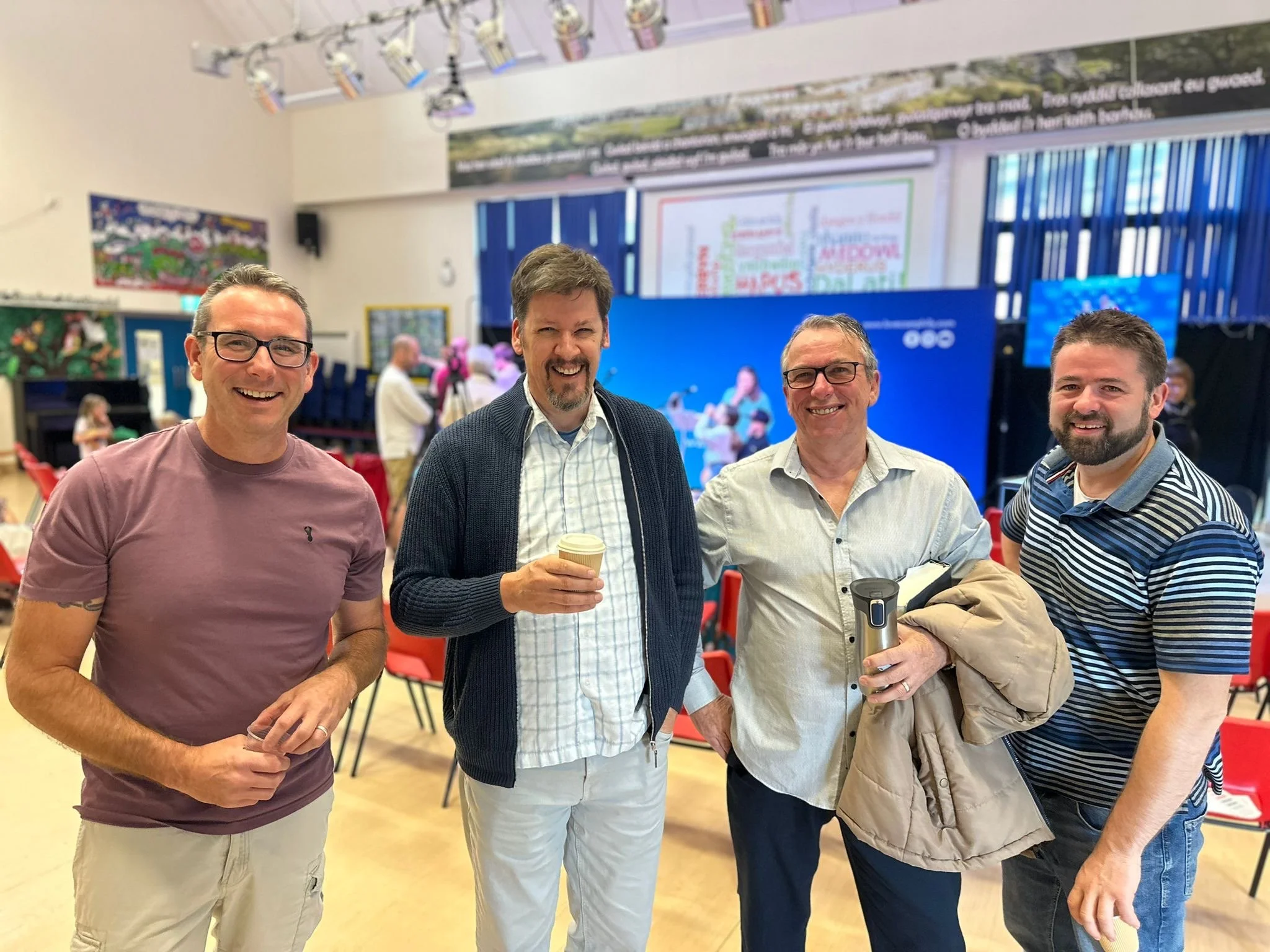 Four men drink coffee together at church in Caerphilly