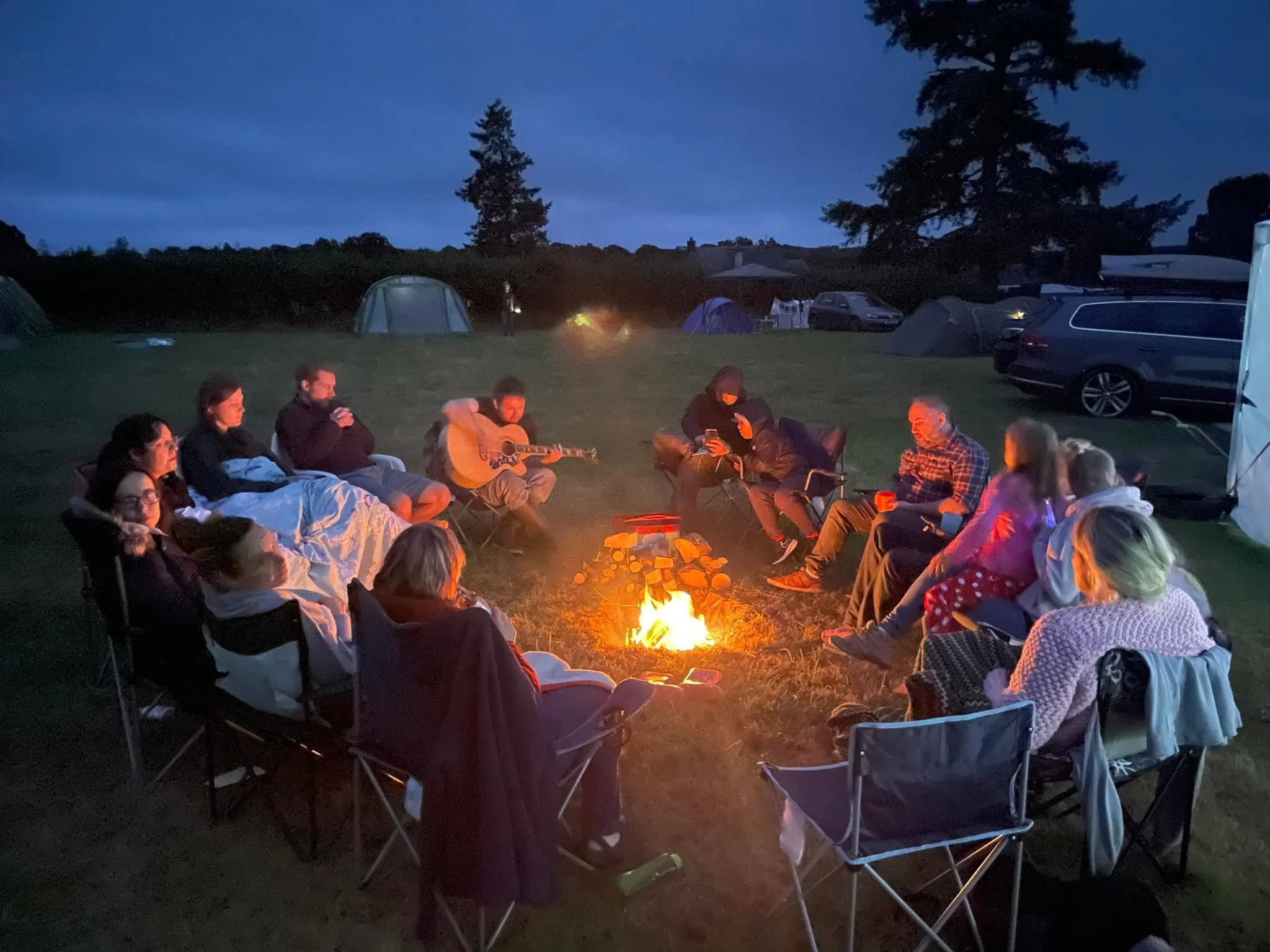 Singing songs around a church campfire with Love Caerphilly