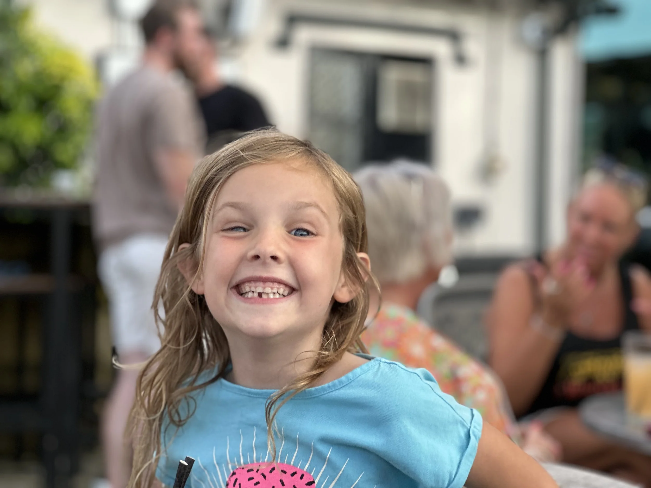 A young girl grins with manic joy at Caerphilly