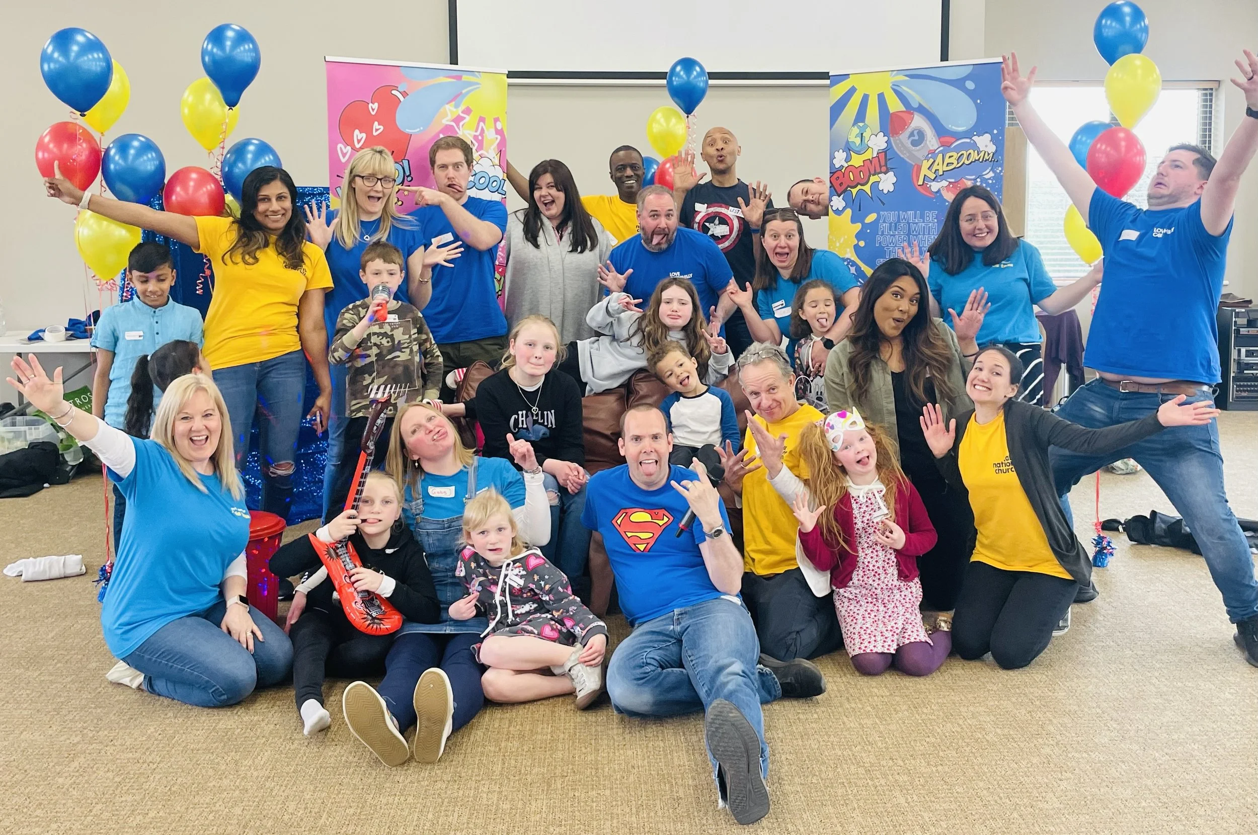 Large group of children and church workers from Love Caerphilly celebrate with balloons