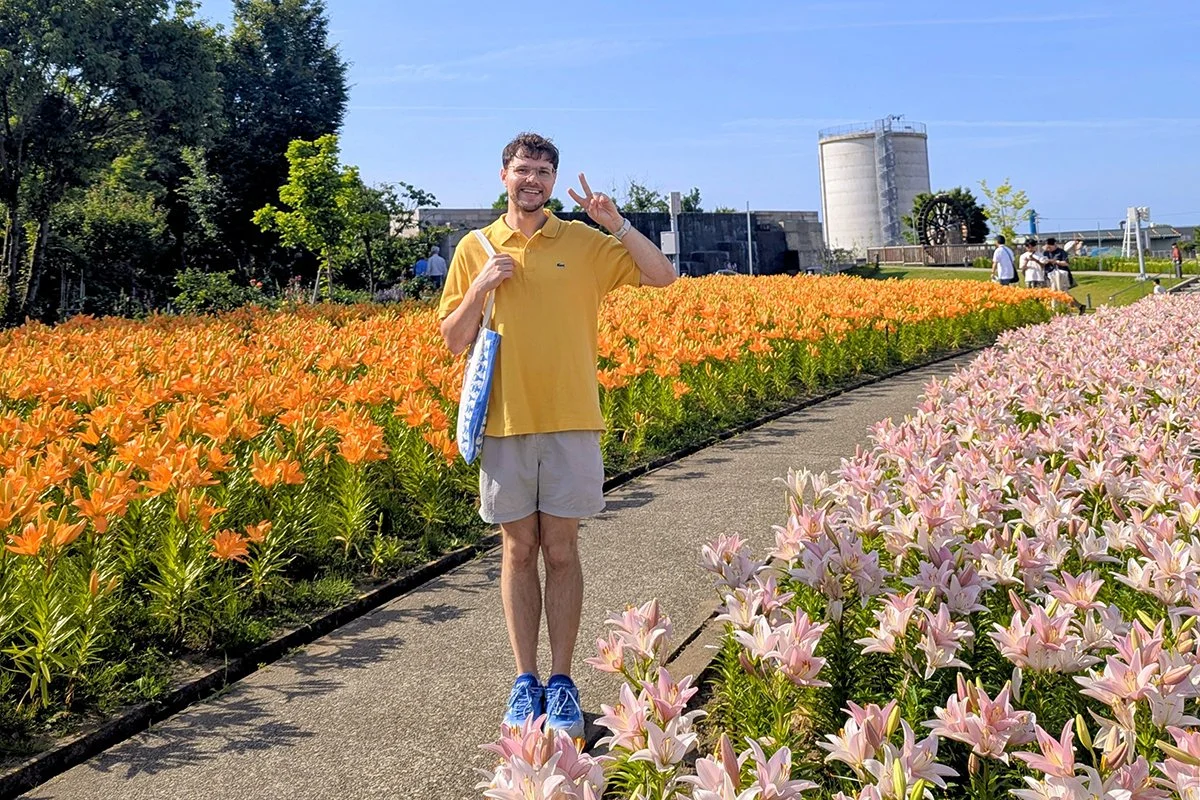 Posing with blooming lilies at Yuri-no-Sato Park (ゆりの里公園), Sakai, Fukui Prefecture, Japan (2026).