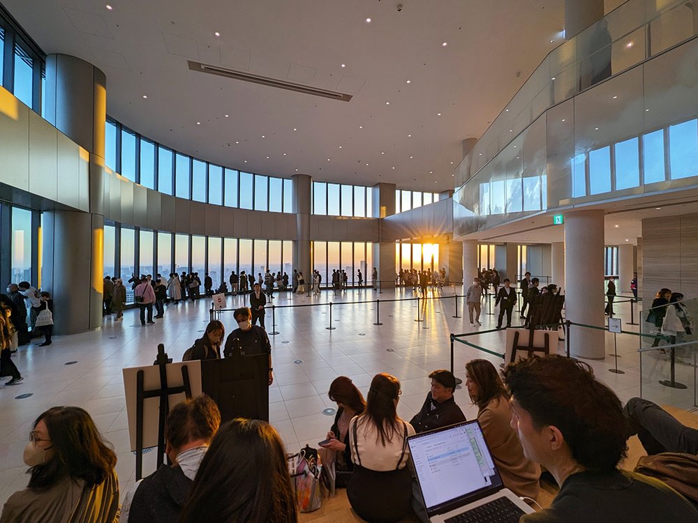  Visitors wait for sunset at the “Sky Lobby” at Azabudai Hills Mori JP Tower, Minato City, Tokyo, Japan (2023). Photo by Danny With Love. 