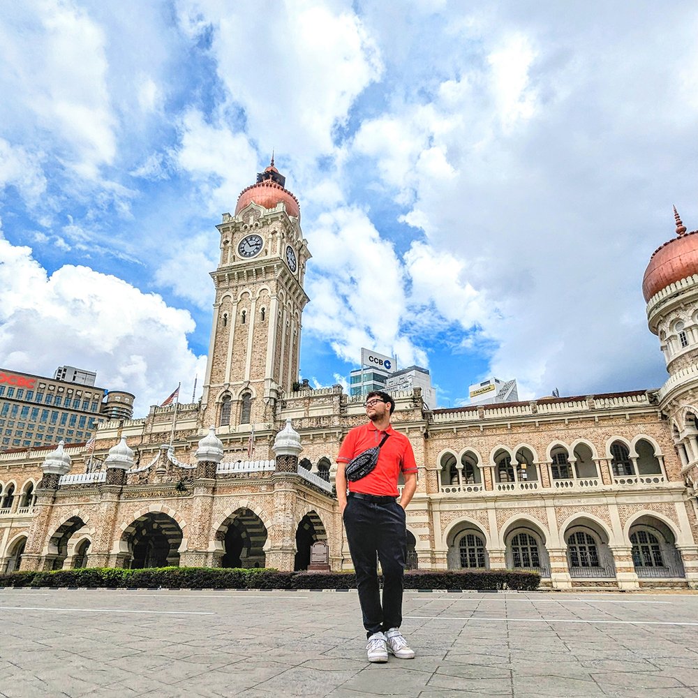  Posing outside the Moor-inspired Sultan Abdul Samad Building, built in 1897, by Dataran Merdeka ('“Independence Square”), Kuala Lumpur, Malaysia (2023). 