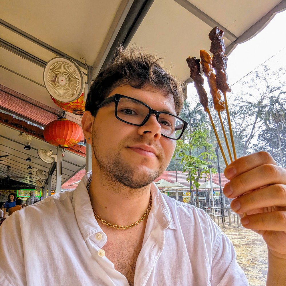  Posing with satay (meat skewers) at Newton Centre, Singapore (2023). Photo by Danny With Love. 