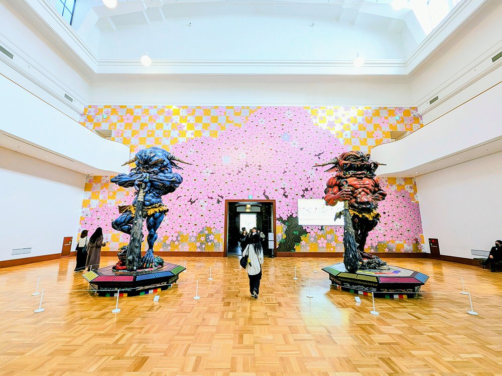  Entrance to the exhibiti on Takashi Murakami Mononoke Kyoto  featuring statues  Embodiment of Um and A  (2014), acrylic, FRP, stainless steel, and zelkova wood, Kyoto City Kyocera Museum of Art, Kyoto, Japan (2024). Photo by Danny With Love. 