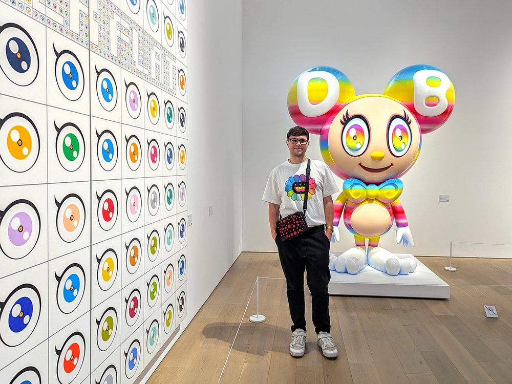  Posing with  Light Box (DOB)  by Takashi Murakami at the Kyoto City Kyocera Museum of Art, Kyoto, Japan (2024). 