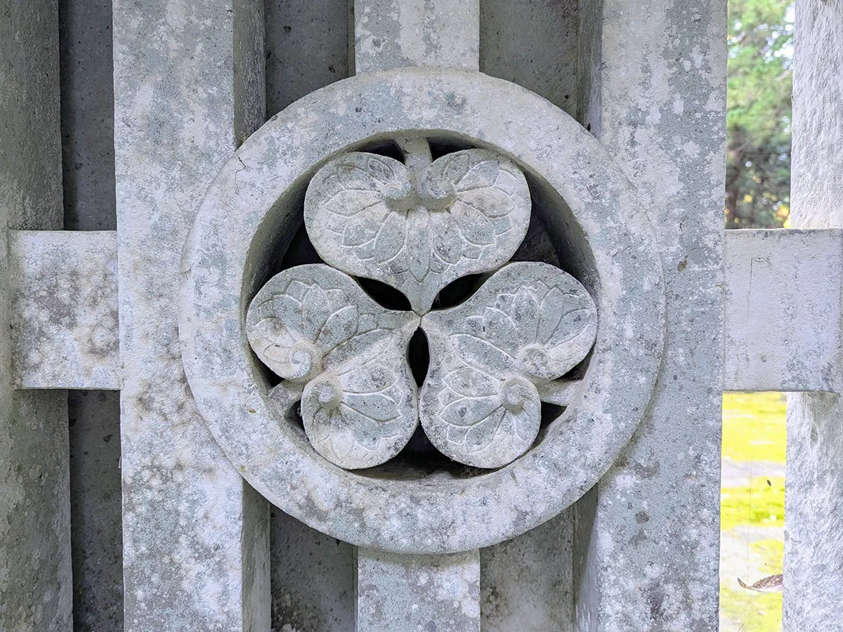 Aoi (hollyhock) crest of the Tokugawa and Matsudaira families carved in Shakudani stone at Senjojiki Cemetery (千畳敷), Daianzenji Temple (大安禅寺), Fukui City, Fukui Prefecture, Japan (2026). Photo by Danny With Love.
